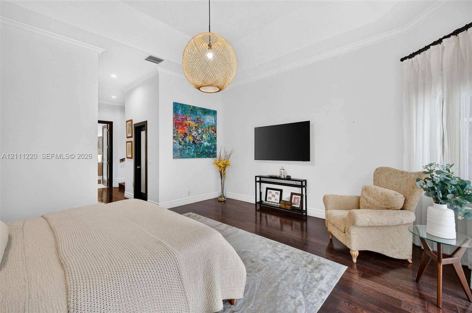134 Dockside Terrace, Weston, FL 33327 Tray ceiling, dark wood-finish flooring, crown molding, and woven spherical pendant lighting