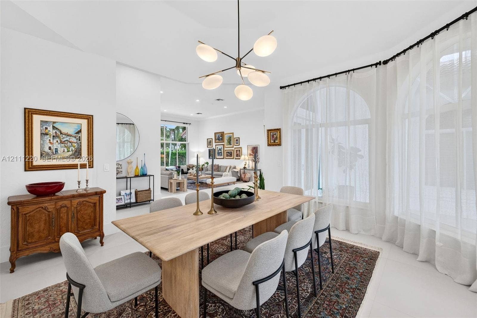 134 Dockside Terrace, Weston, FL 33327 Dining space featuring arched windows, light-toned flooring, and a multi-arm modern chandelier