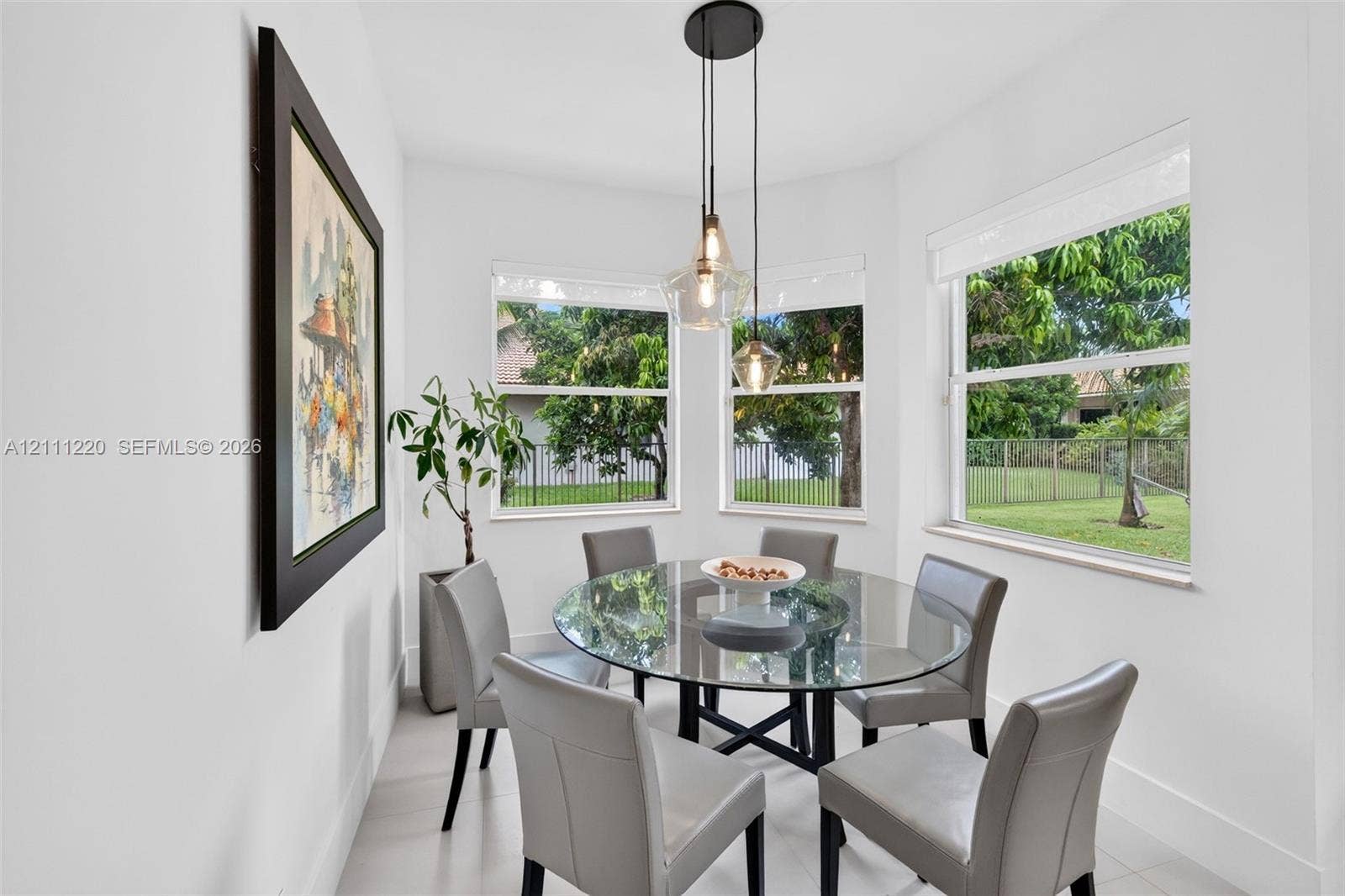 134 Dockside Terrace, Weston, FL 33327 Sun-filled nook featuring triple-pane corner windows, pendant lighting with glass shades, and neutral floor tiling