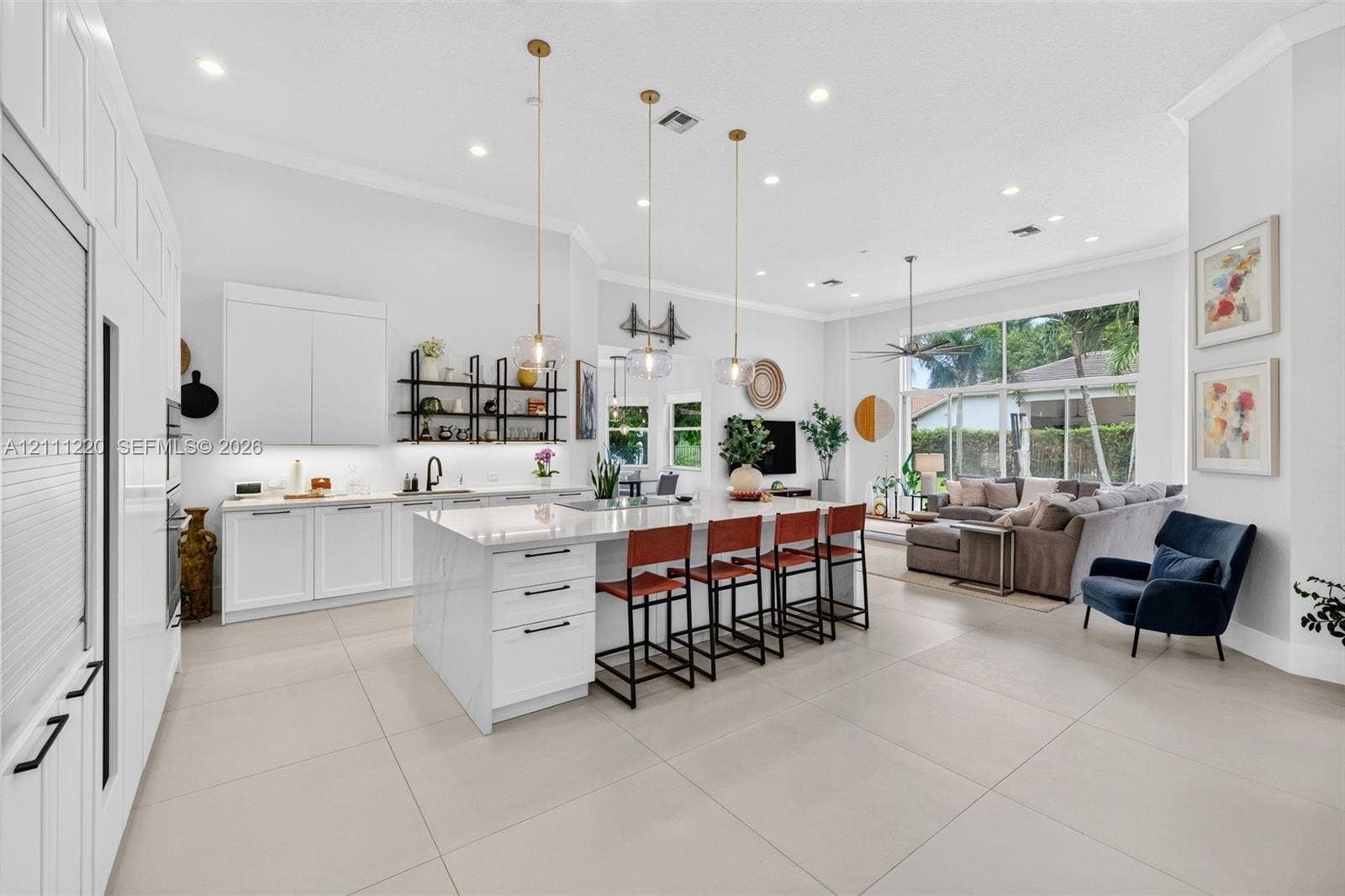 134 Dockside Terrace, Weston, FL 33327 Kitchen featuring a large central island with quartz surfacing, floor-to-ceiling white cabinetry, matte black hardware, recessed lighting, and large-format tile flooring