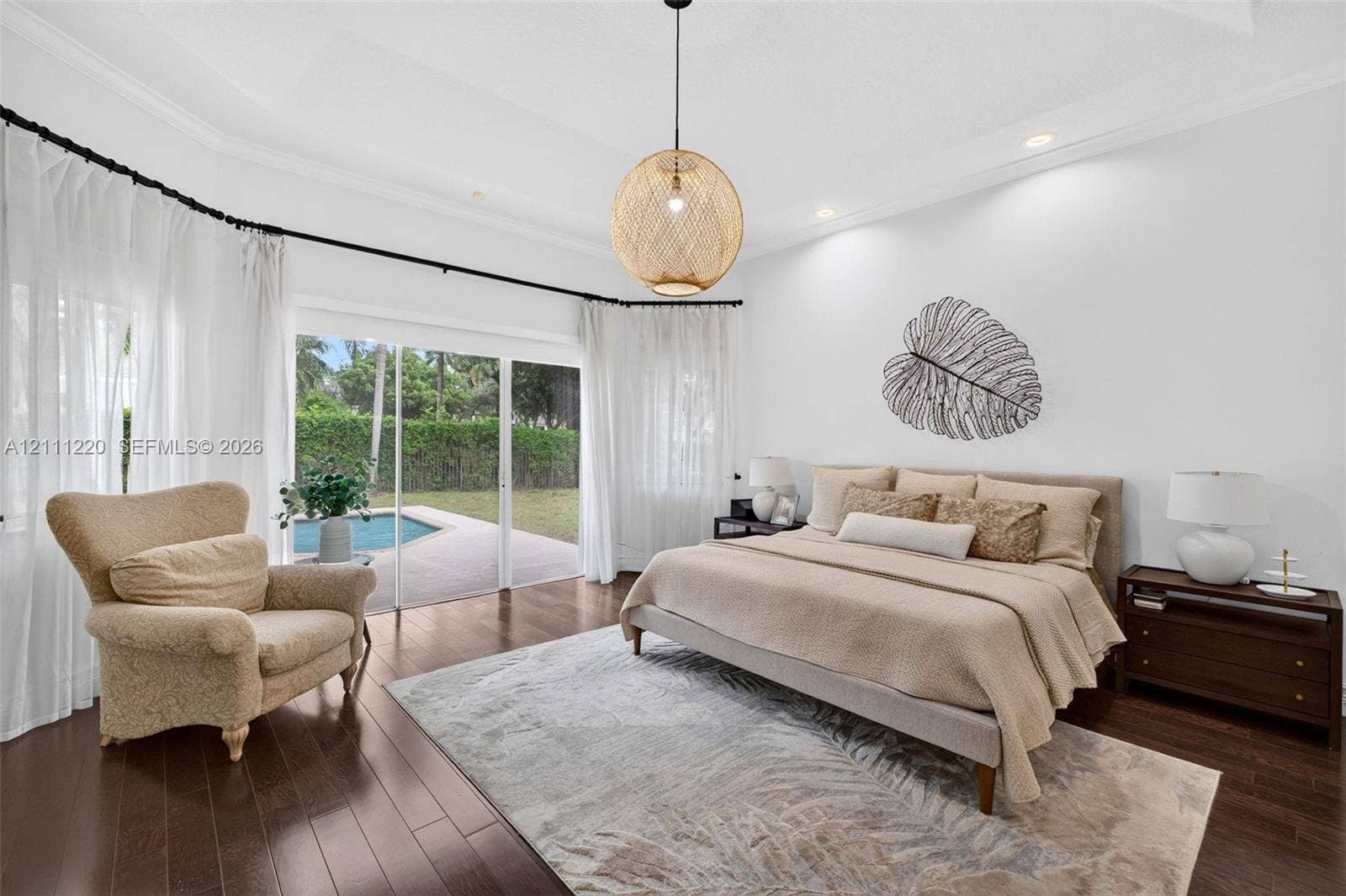 134 Dockside Terrace, Weston, FL 33327 Tray ceiling with recessed lighting, dark wood-finish flooring, and sliding glass doors opening to an exterior swimming pool