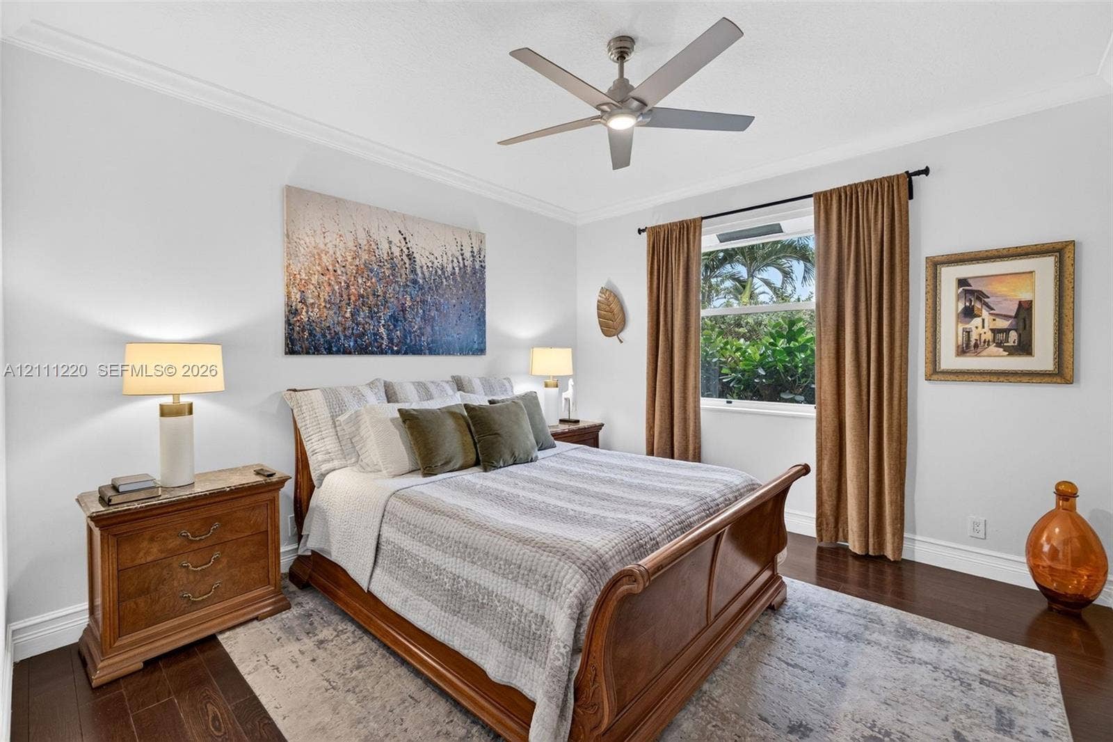 134 Dockside Terrace, Weston, FL 33327 Dark-toned wood-finish flooring, ceiling fan with integrated lighting, and crown molding