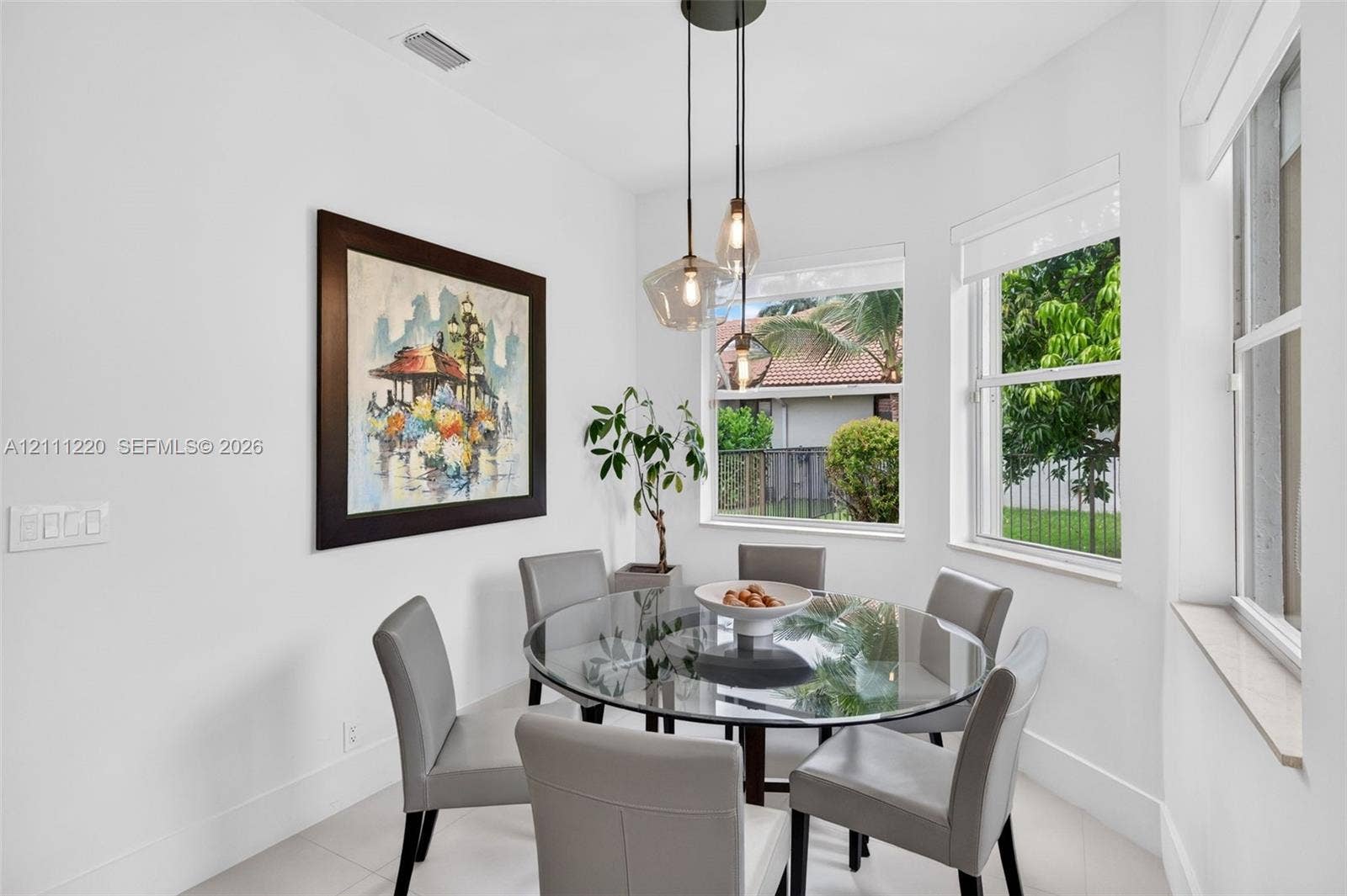 134 Dockside Terrace, Weston, FL 33327 Nook featuring triple-pendant light fixture, large pane windows, and neutral tile flooring