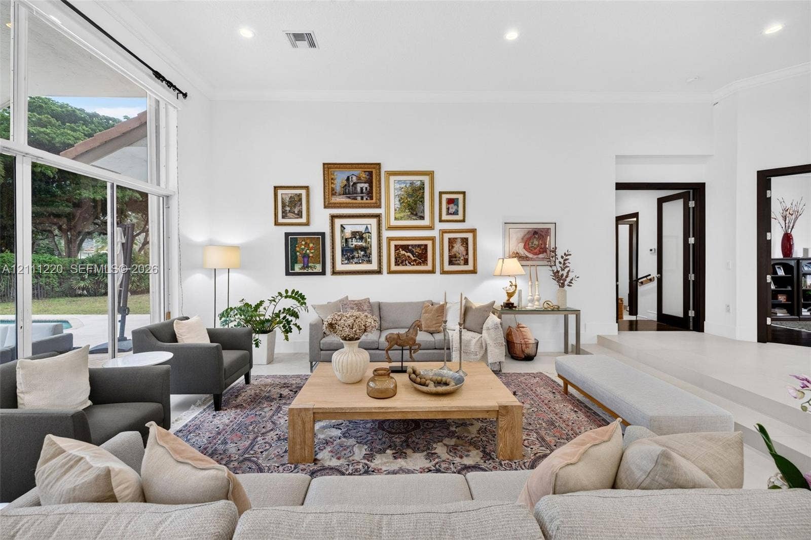 134 Dockside Terrace, Weston, FL 33327 Living area featuring high ceilings, large-format tile flooring, recessed lighting, and expansive floor-to-ceiling windows