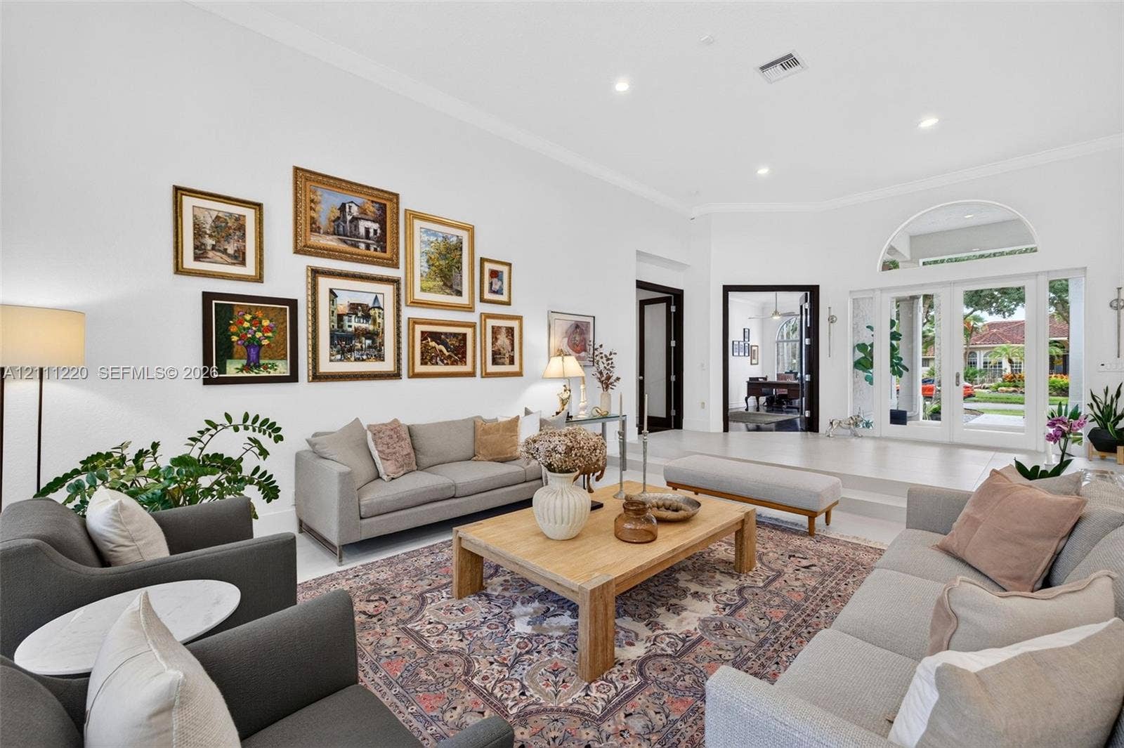 134 Dockside Terrace, Weston, FL 33327 High ceilings featuring recessed lighting, expansive glass double doors with an arched transom, and light-toned hard-surface flooring