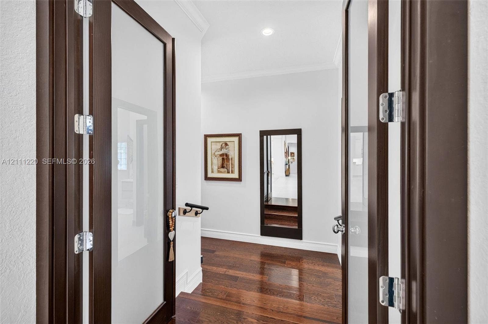 134 Dockside Terrace, Weston, FL 33327 Double doors featuring dark wood frames with frosted glass panels, wood-finish flooring, and recessed ceiling lighting