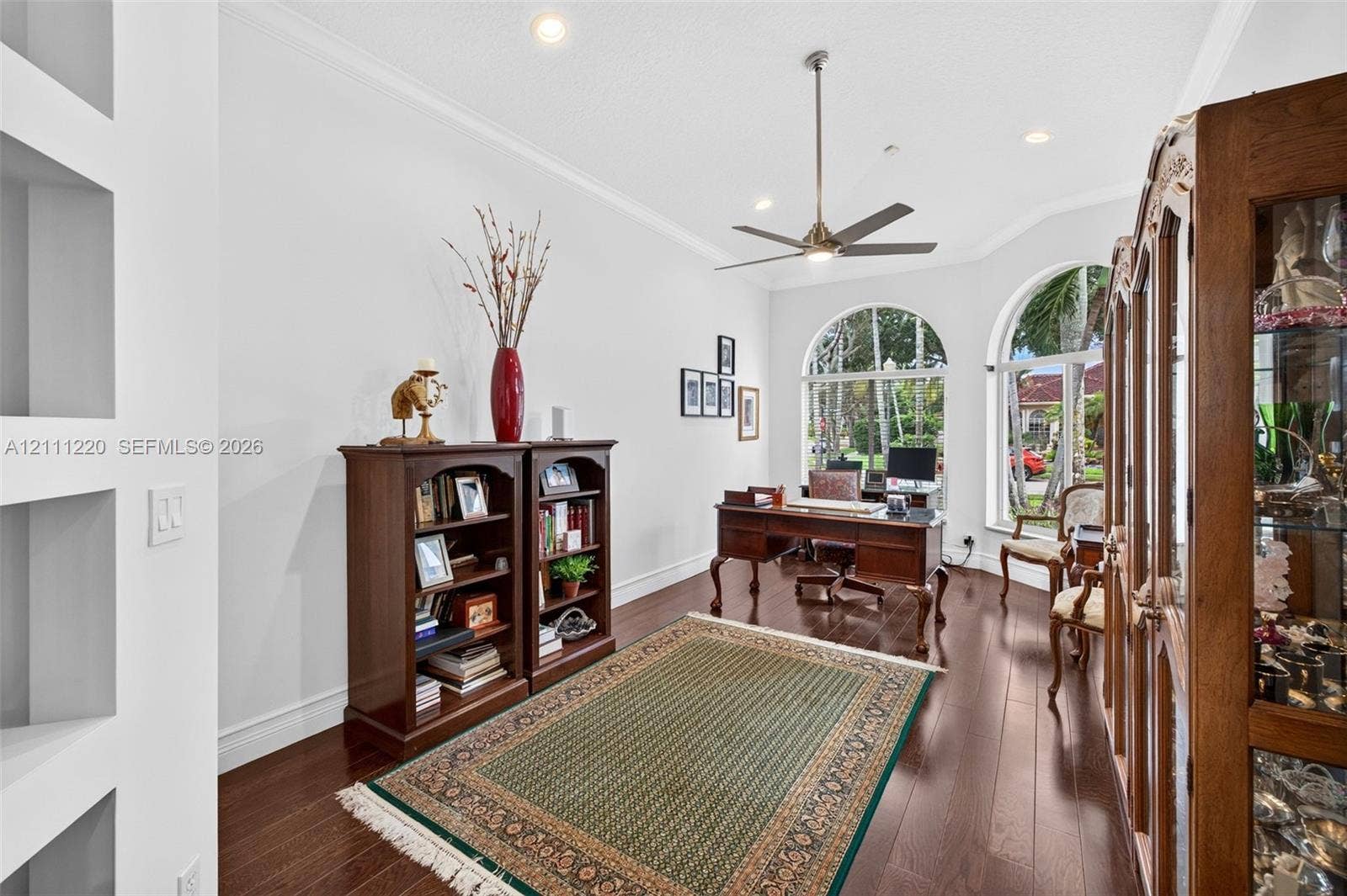 134 Dockside Terrace, Weston, FL 33327 Room featuring wood-finish flooring, recessed lighting, crown molding, built-in wall niches, and arched windows