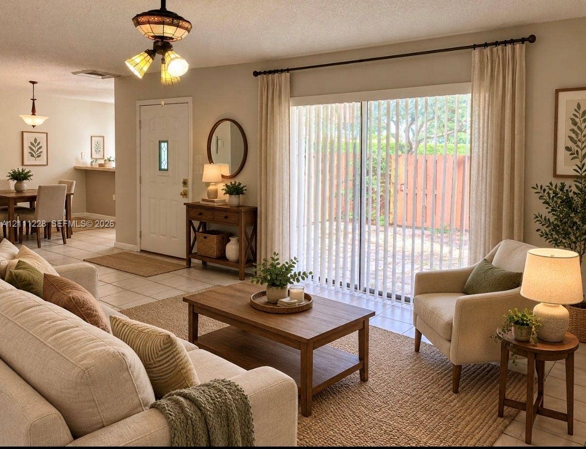 Ceramic tile flooring, sliding glass door with vertical blinds, multi-light decorative overhead fixture, and raised-panel entry door