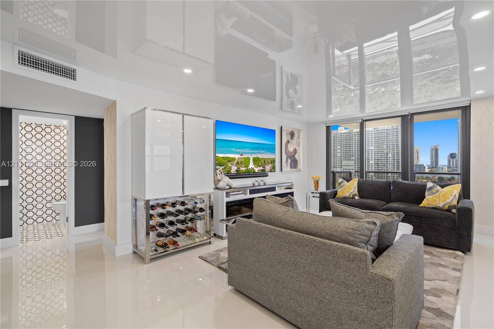 High-gloss reflective ceiling, full-height windows, custom built-in beverage storage unit, and polished tile flooring