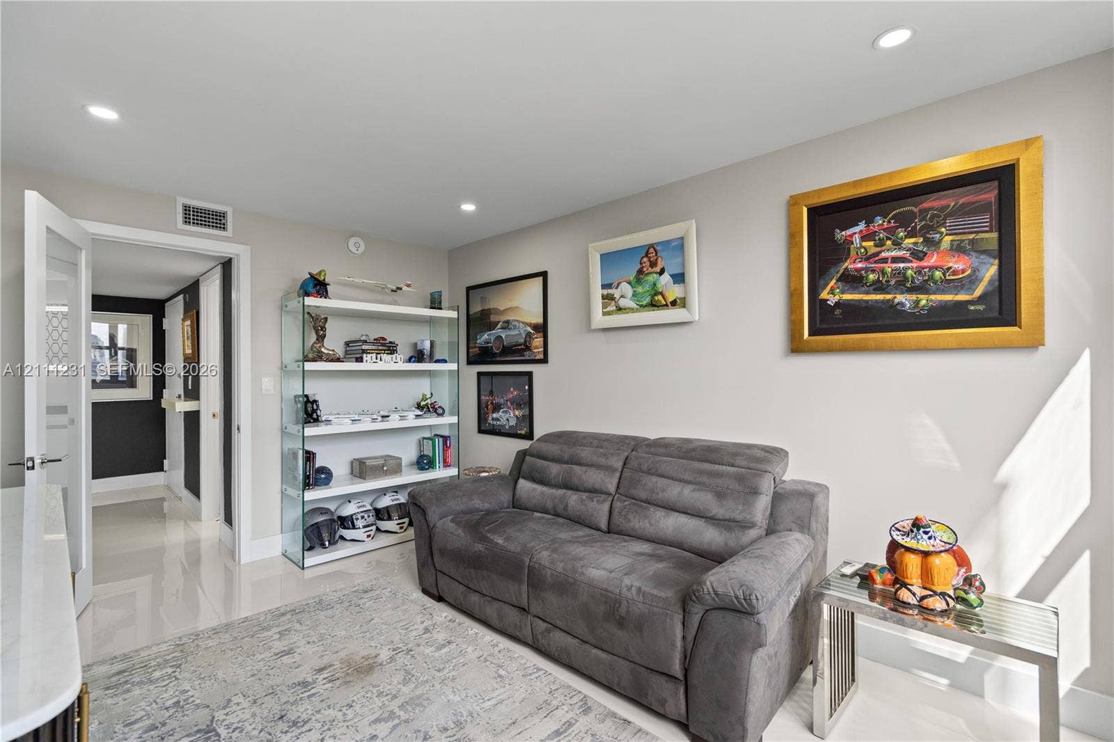 Neutral interior space featuring polished tile flooring, recessed lighting, and a neutral wall color palette
