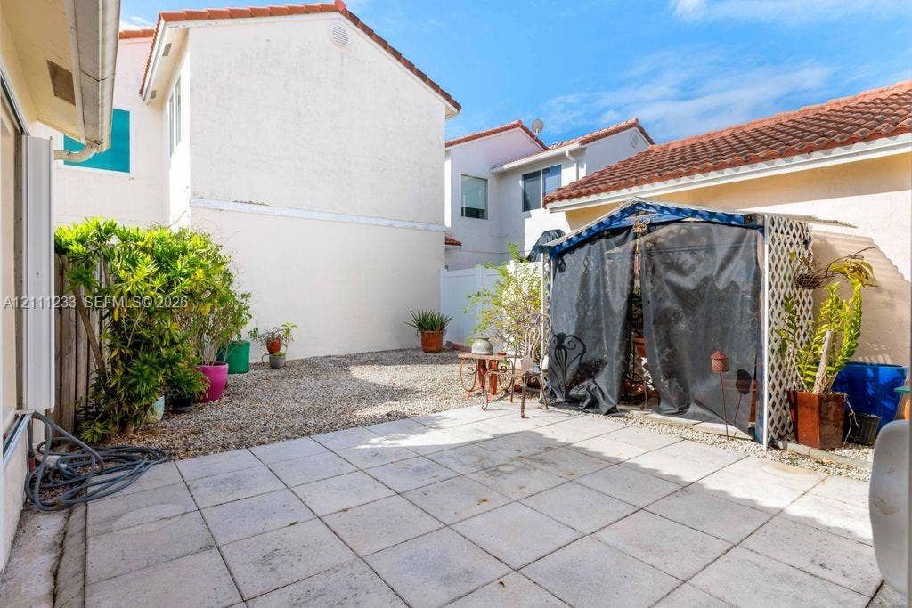 17826 SW 10th Lane, Pembroke Pines, FL 33029 Private courtyard featuring square paver patio, stone-surfaced ground, and stucco exterior walls