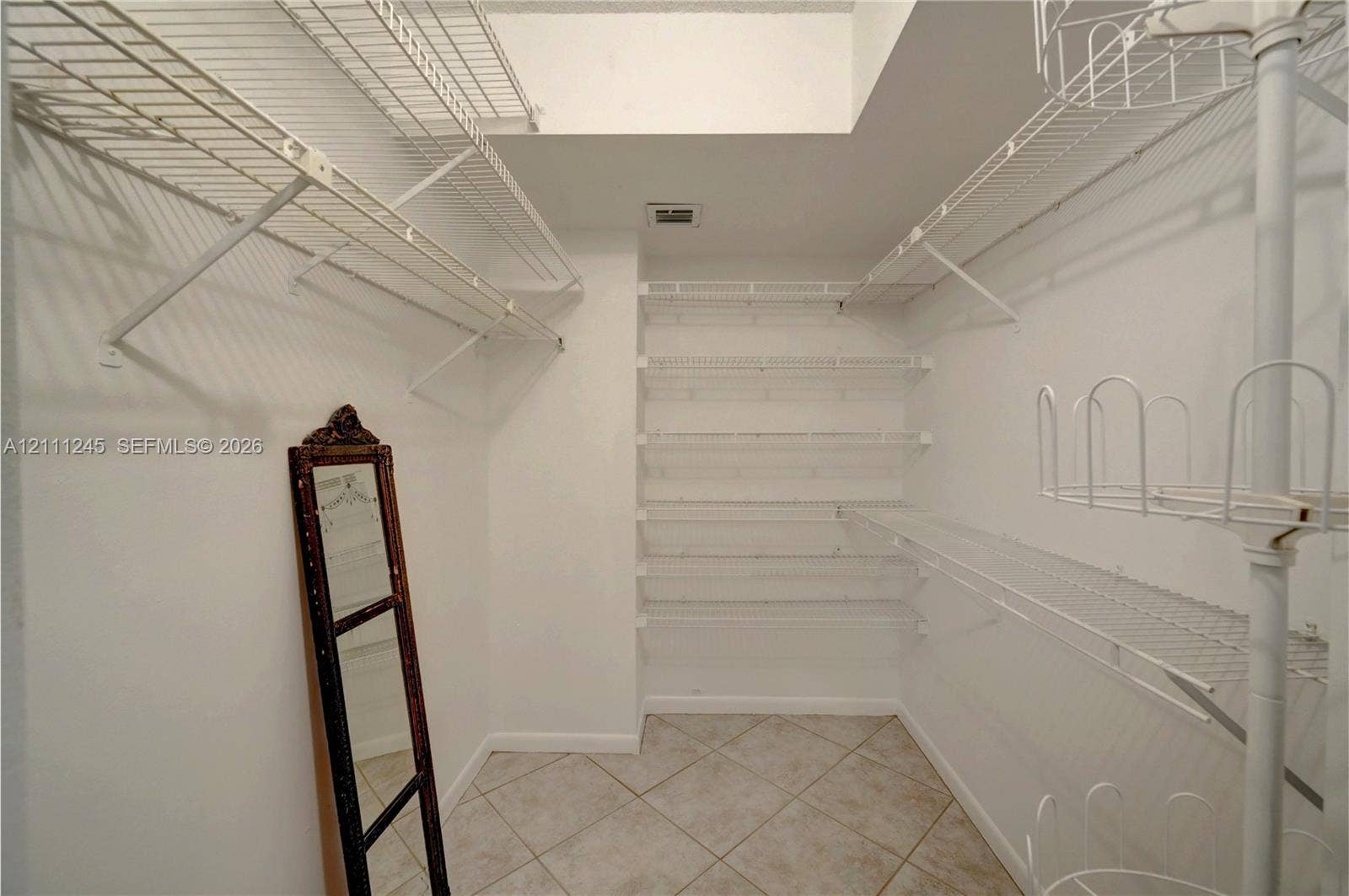 6800 Cypress Road, #506, Plantation, FL 33317 Walk-in storage space featuring ceramic tile flooring and multi-level white wire shelving