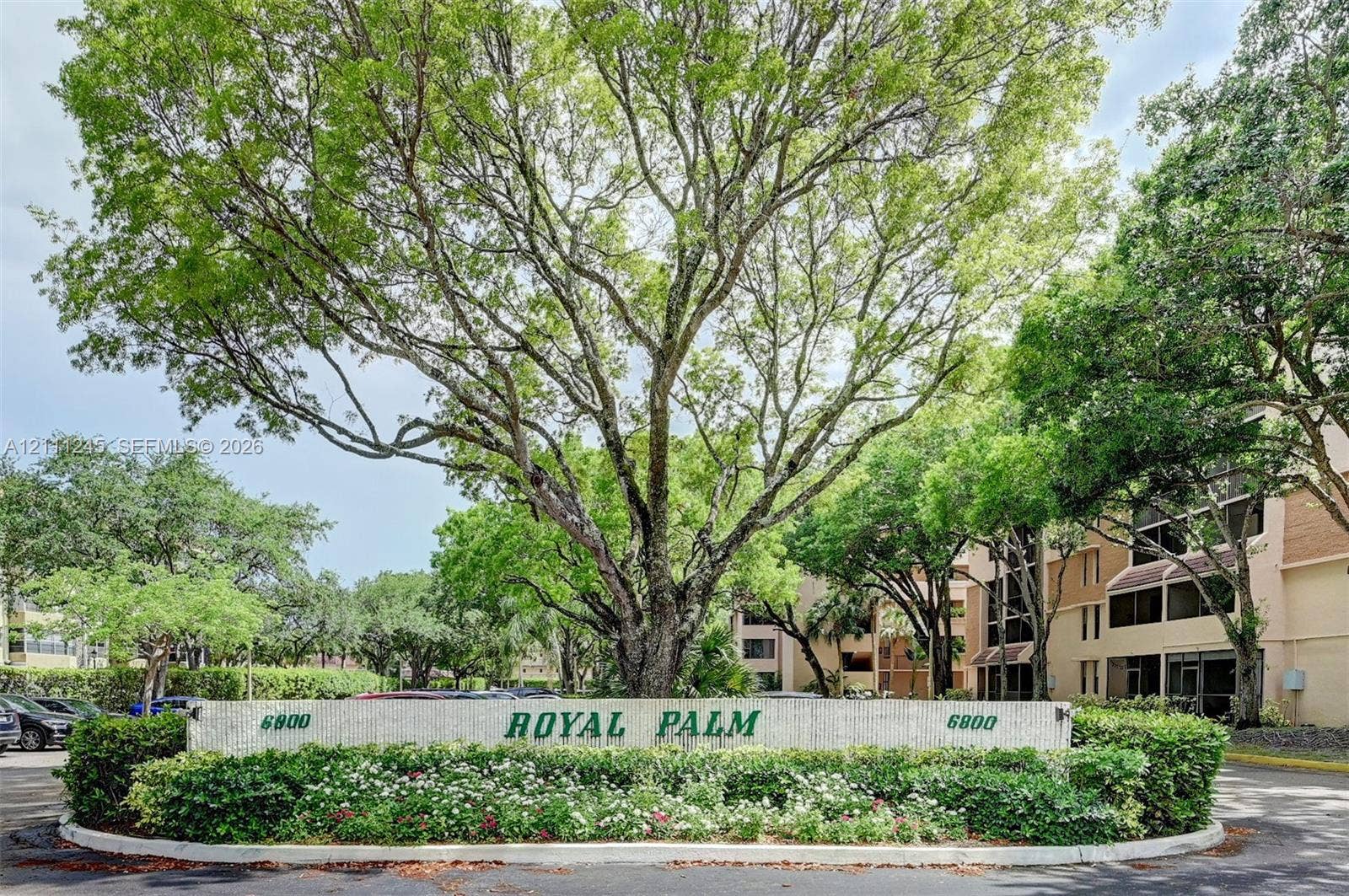 6800 Cypress Road, #506, Plantation, FL 33317 Monument entrance sign with stone-finish base, integrated landscaping, and large mature shade trees