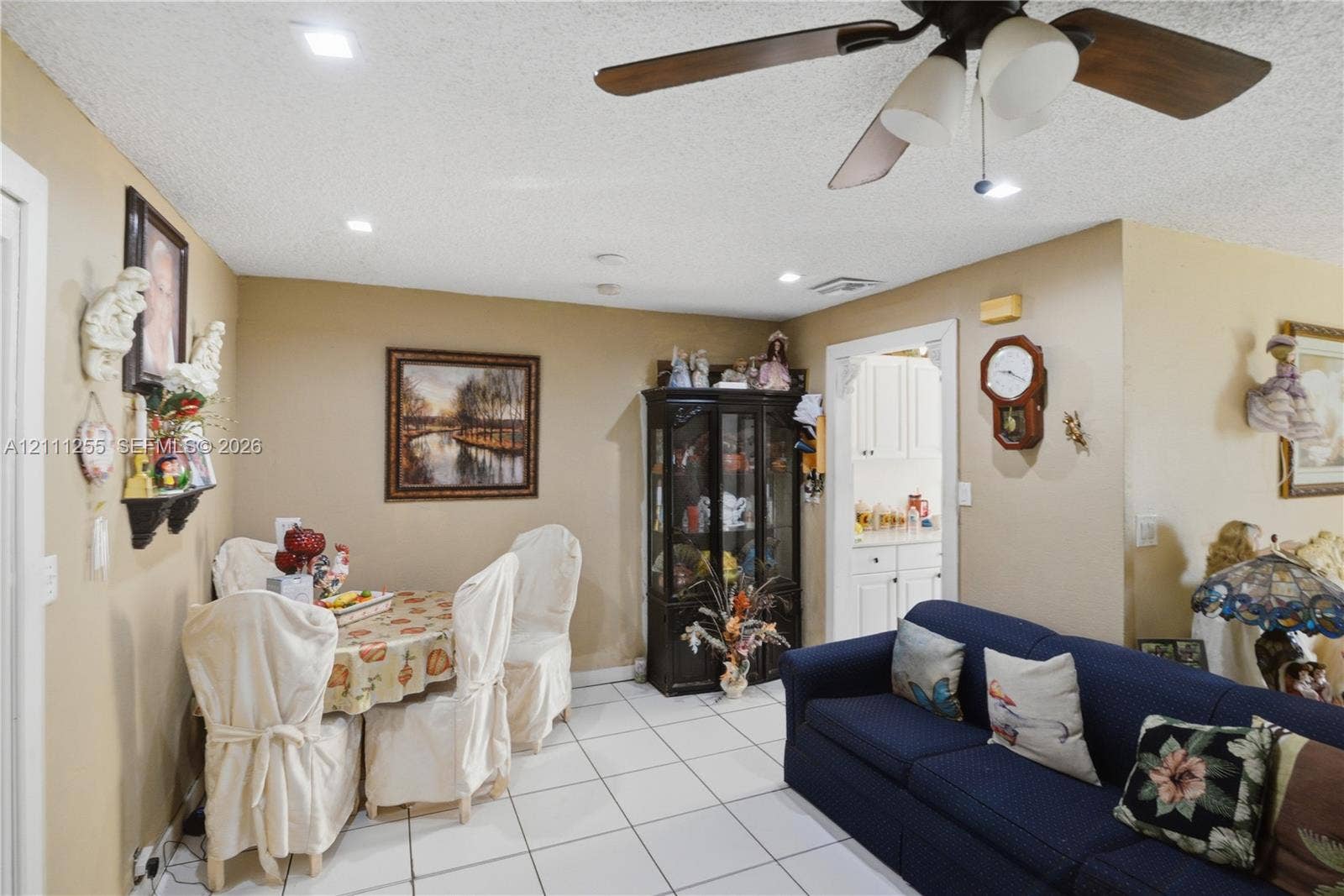Ceramic tile flooring, ceiling fan with integrated lighting, and recessed ceiling lighting