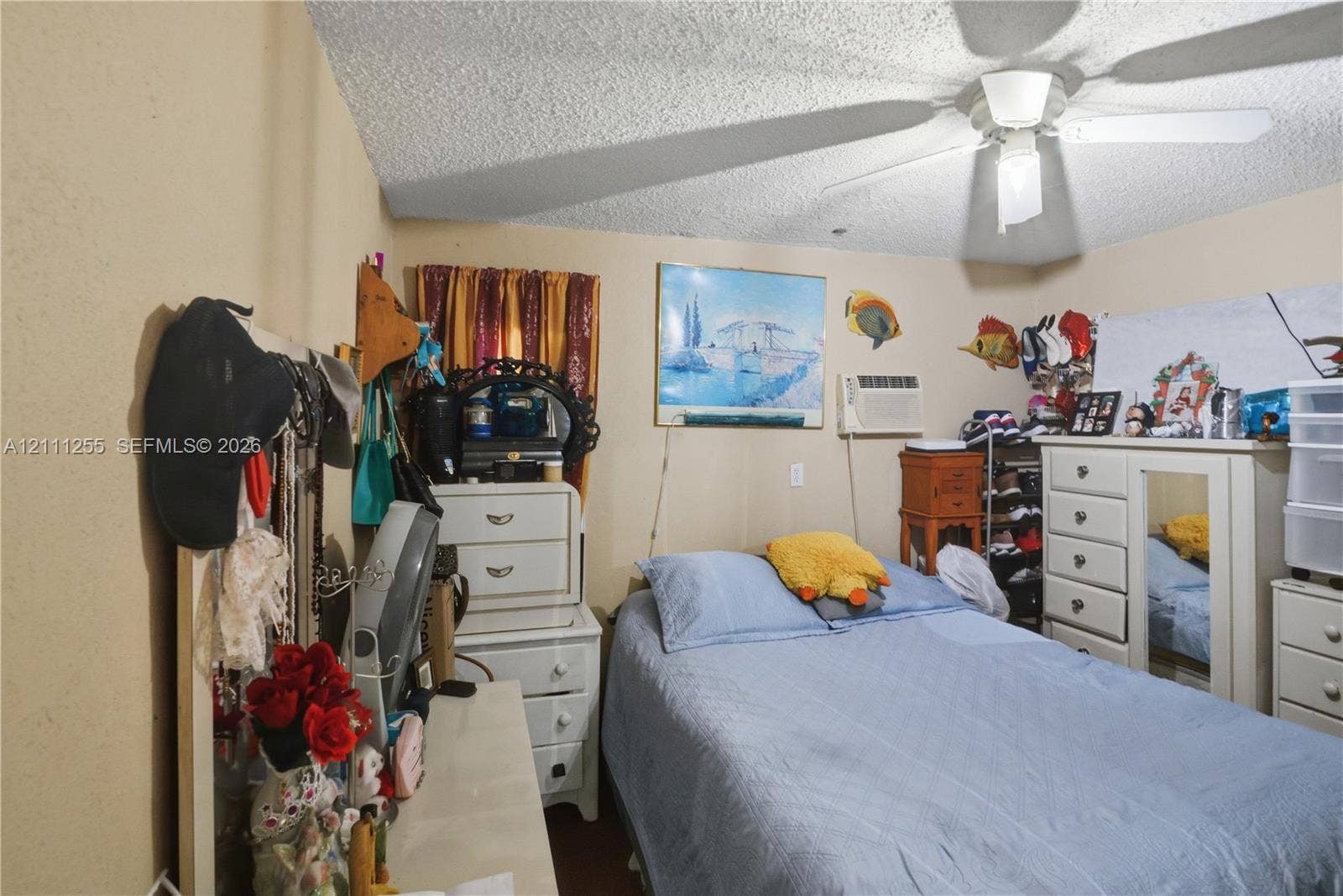 Ceiling-mounted light fixture with integrated fan and wall-mounted air conditioning unit