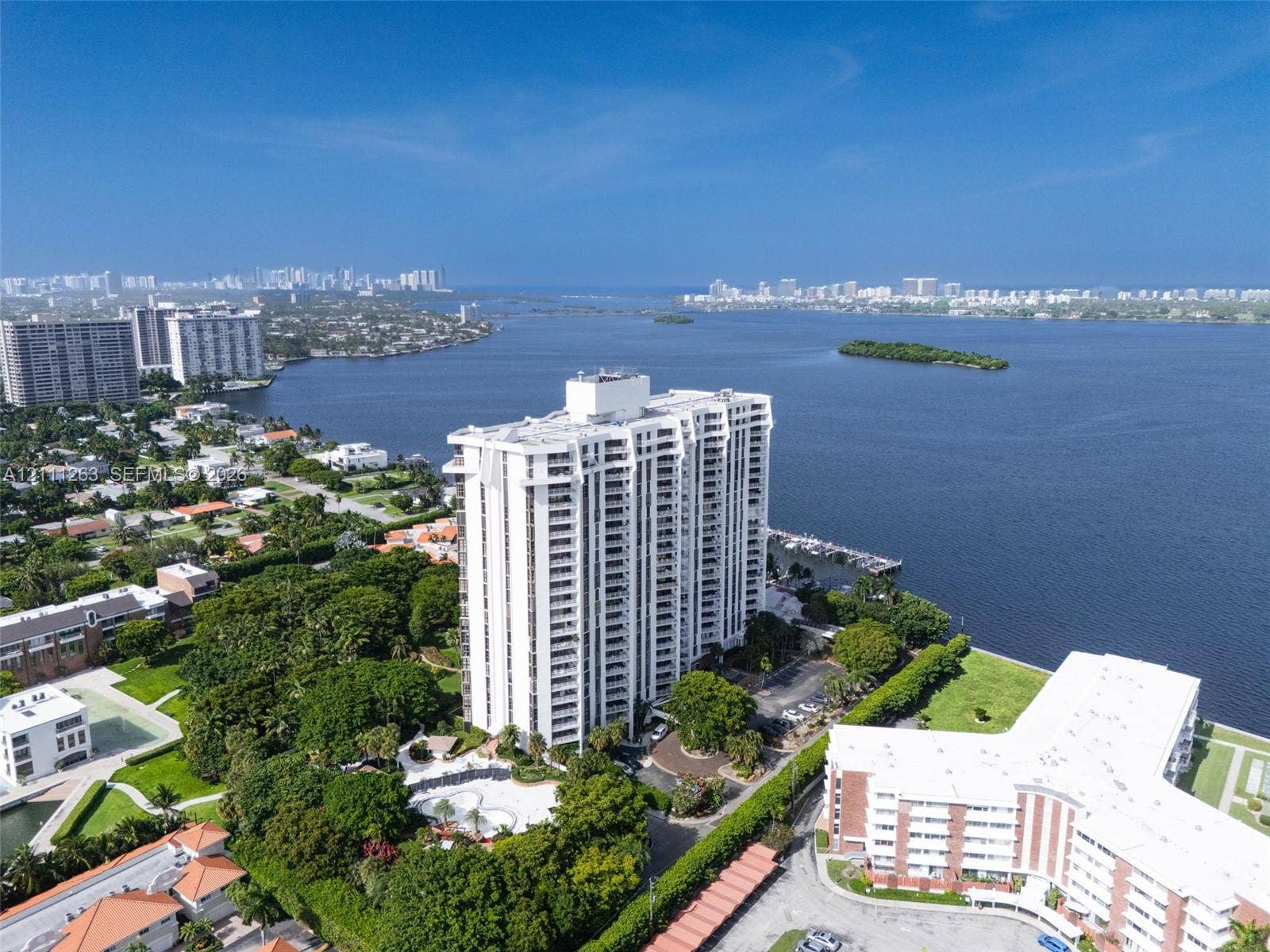 4000 Towerside Terrace, #604, Miami, FL 33138 High-rise residential building situated on the waterfront featuring a swimming pool, private boat slips, and extensive perimeter landscaping