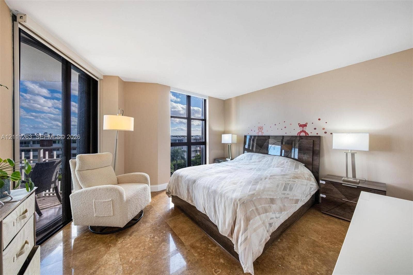 4000 Towerside Terrace, #604, Miami, FL 33138 Polished stone flooring, floor-to-ceiling windows, and sliding glass doors opening to a balcony