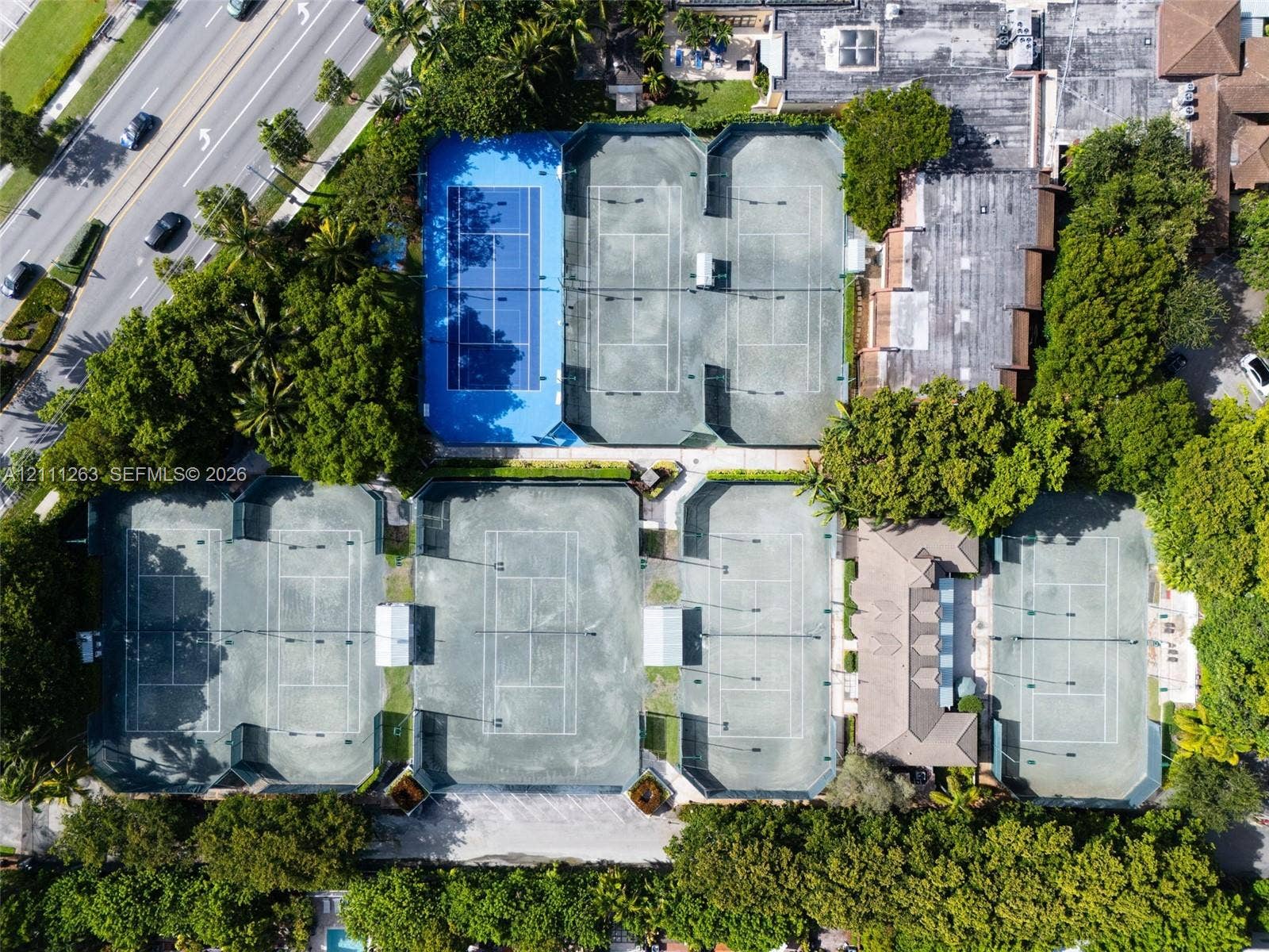 4000 Towerside Terrace, #604, Miami, FL 33138 Aerial view of tennis complex featuring seven hard-court surfaces, perimeter fencing, and mature trees