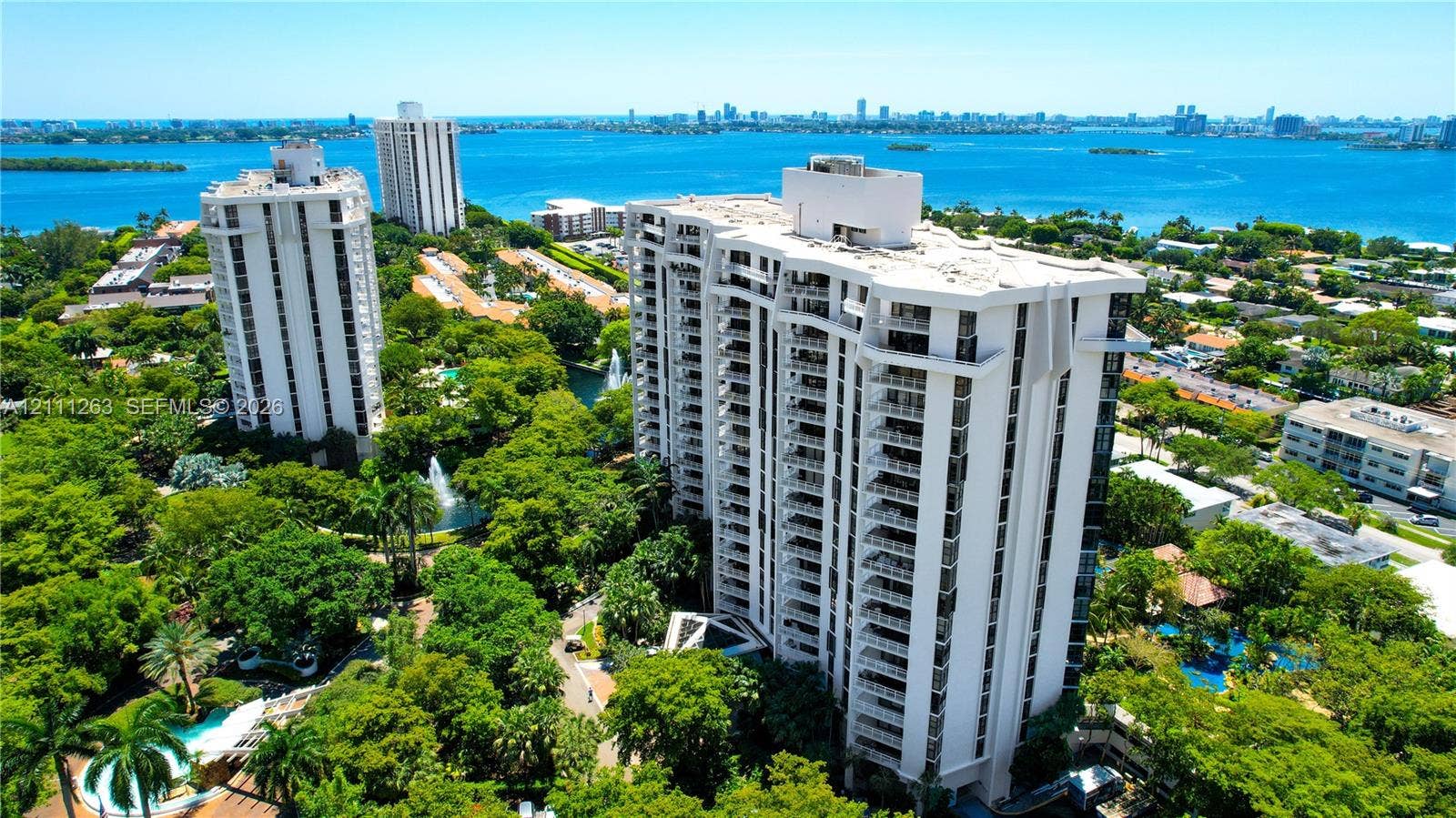 4000 Towerside Terrace, #604, Miami, FL 33138 High-rise condominium featuring private balconies, lush grounds, mature landscaping, and swimming pools