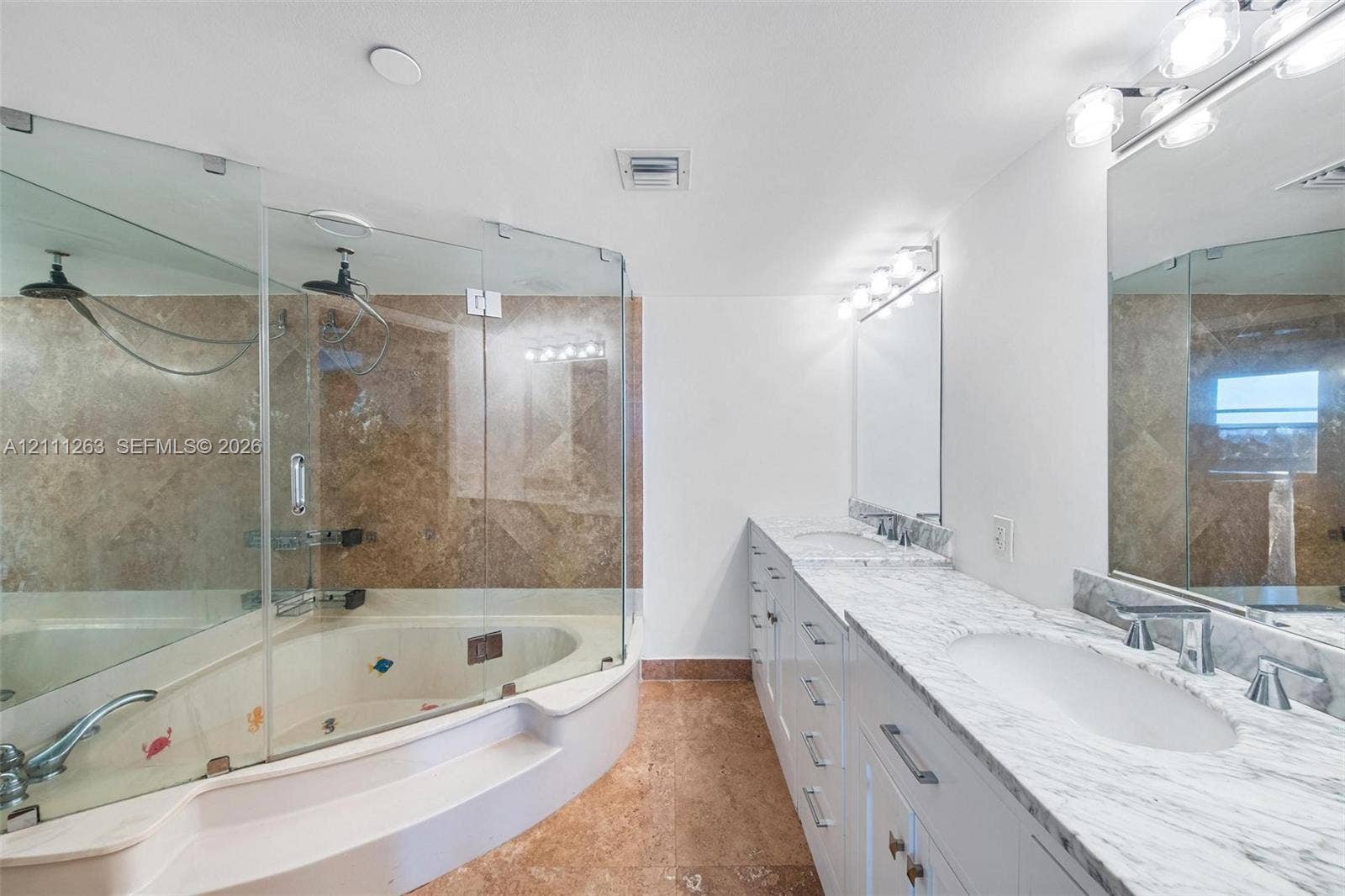 4000 Towerside Terrace, #604, Miami, FL 33138 Bathroom featuring a dual-sink vanity with stone countertops, white cabinetry, a glass-enclosed shower, and a built-in jetted tub with stone tile surround