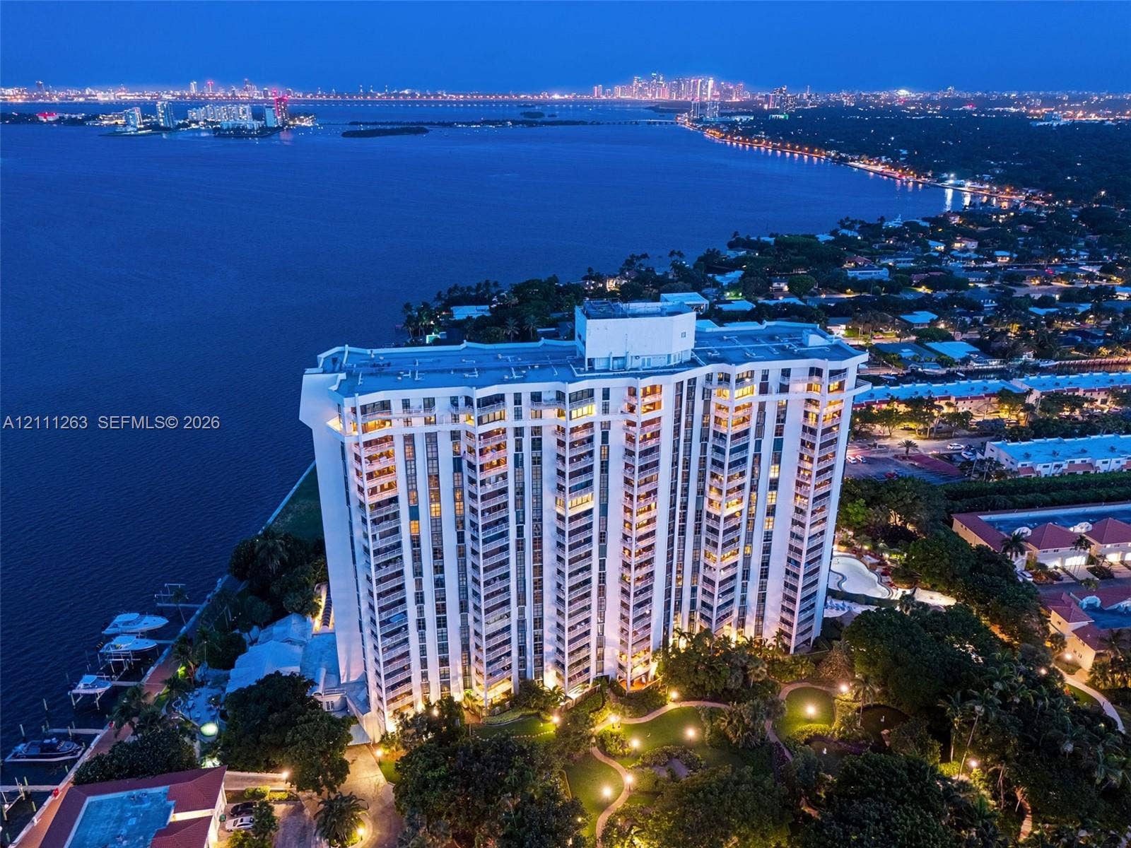 4000 Towerside Terrace, #604, Miami, FL 33138 High-rise building featuring private boat slips, landscaped grounds, a paved walking path, and waterfront positioning
