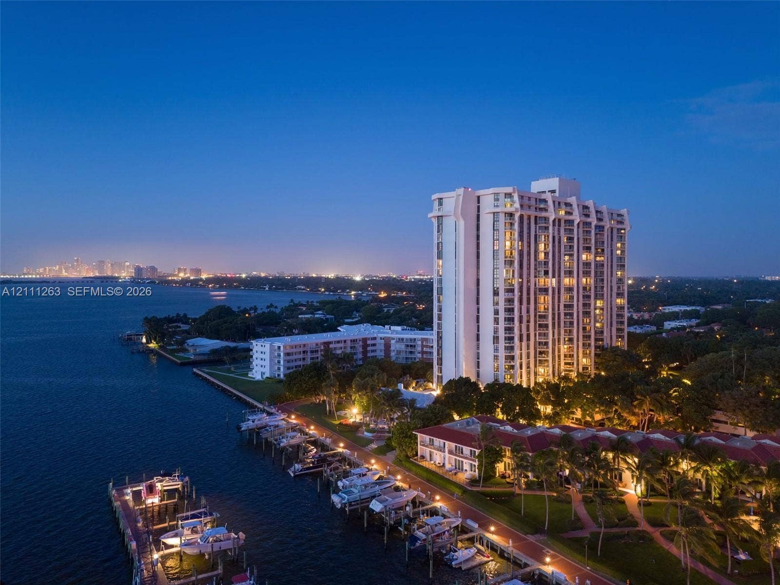 4000 Towerside Terrace, #604, Miami, FL 33138 High-rise residential building featuring waterfront positioning, private boat slips, extensive landscaped grounds, and paved pathways