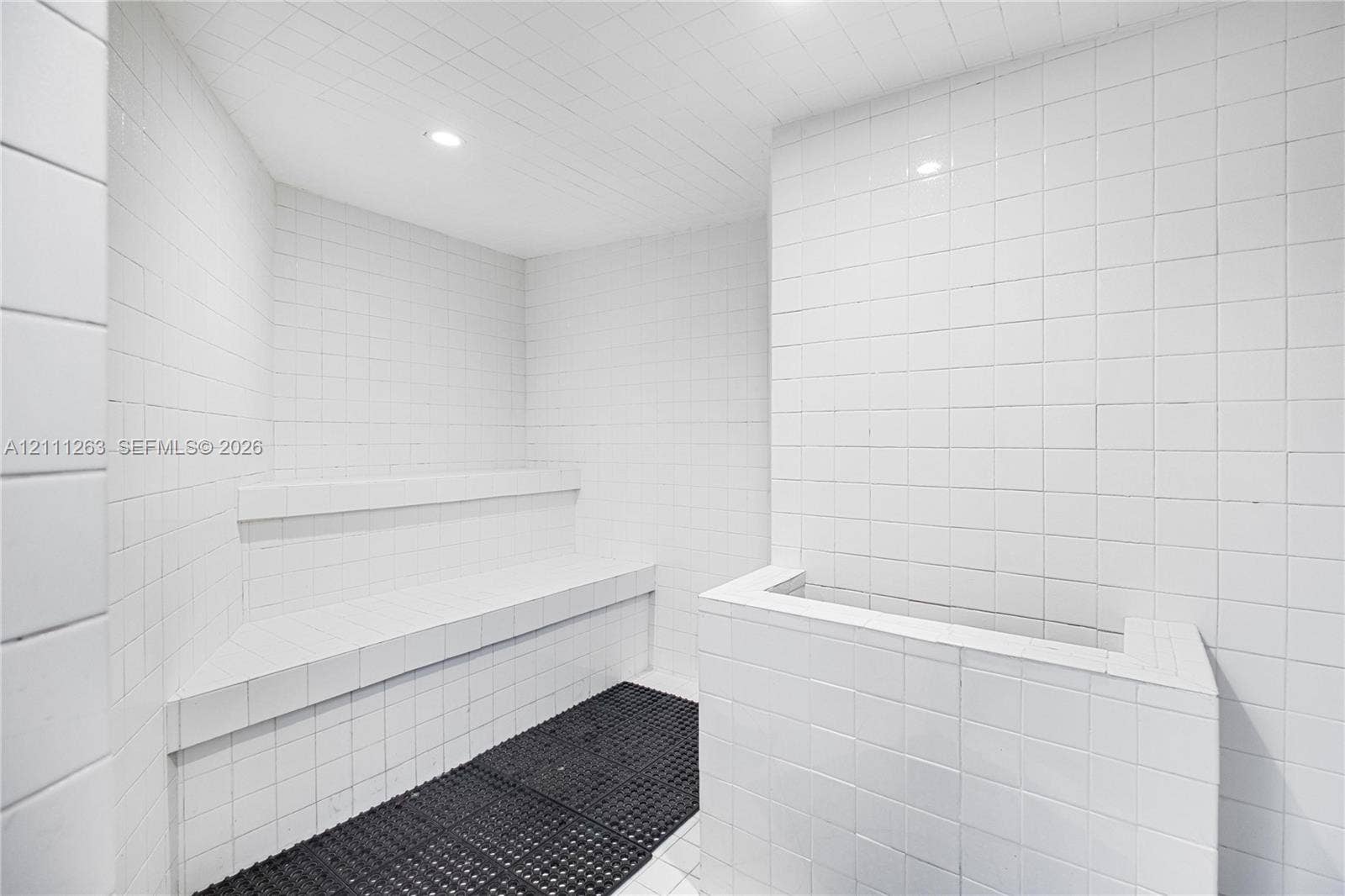 4000 Towerside Terrace, #604, Miami, FL 33138 Steam room featuring white square wall tile, recessed ceiling lighting, and a built-in tiled bench
