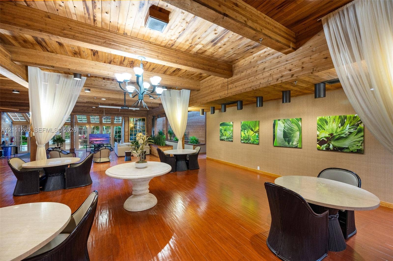 4000 Towerside Terrace, #604, Miami, FL 33138 Exposed timber ceiling beams, wood-finish flooring, multi-light chandelier, and recessed lighting