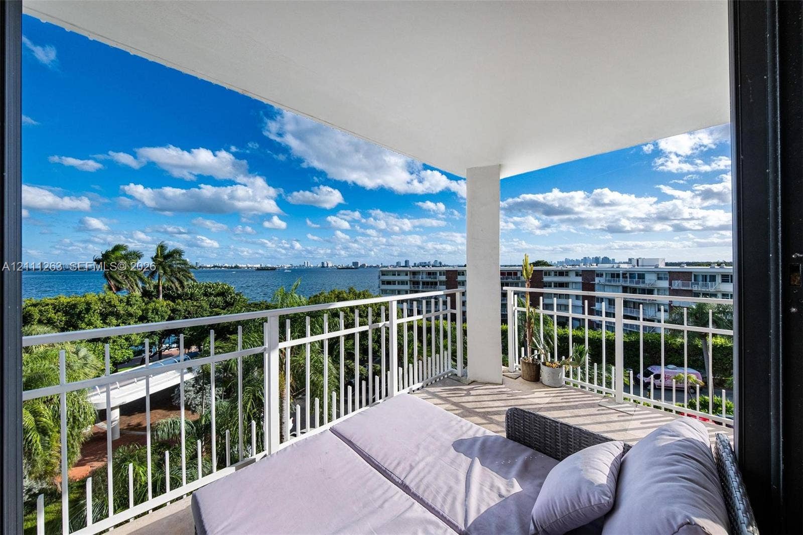 4000 Towerside Terrace, #604, Miami, FL 33138 Covered balcony with white metal railings and expansive water scenery