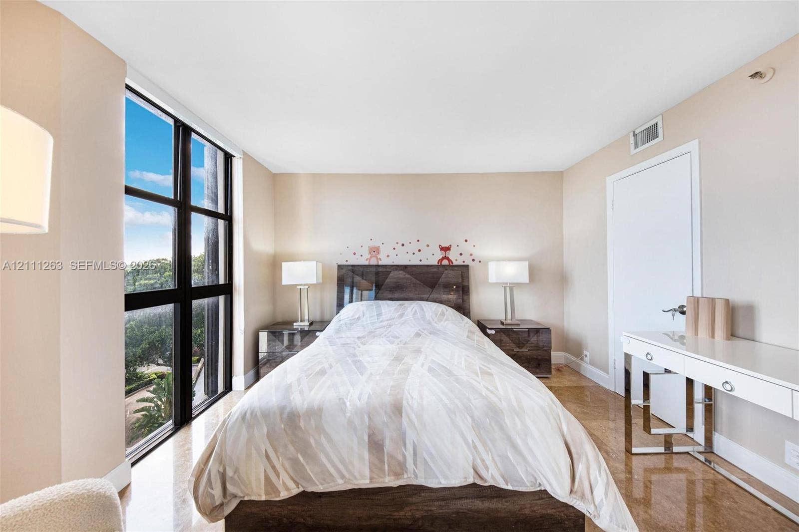 4000 Towerside Terrace, #604, Miami, FL 33138 Floor-to-ceiling windows with grid framing, smooth finish ceiling, neutral wall palette, and polished stone-finish flooring