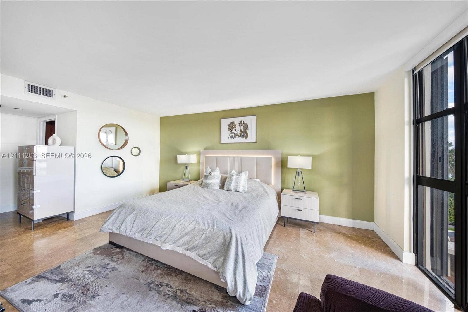 4000 Towerside Terrace, #604, Miami, FL 33138 Floor-to-ceiling windows with black metal frames, stone flooring, and an accent wall