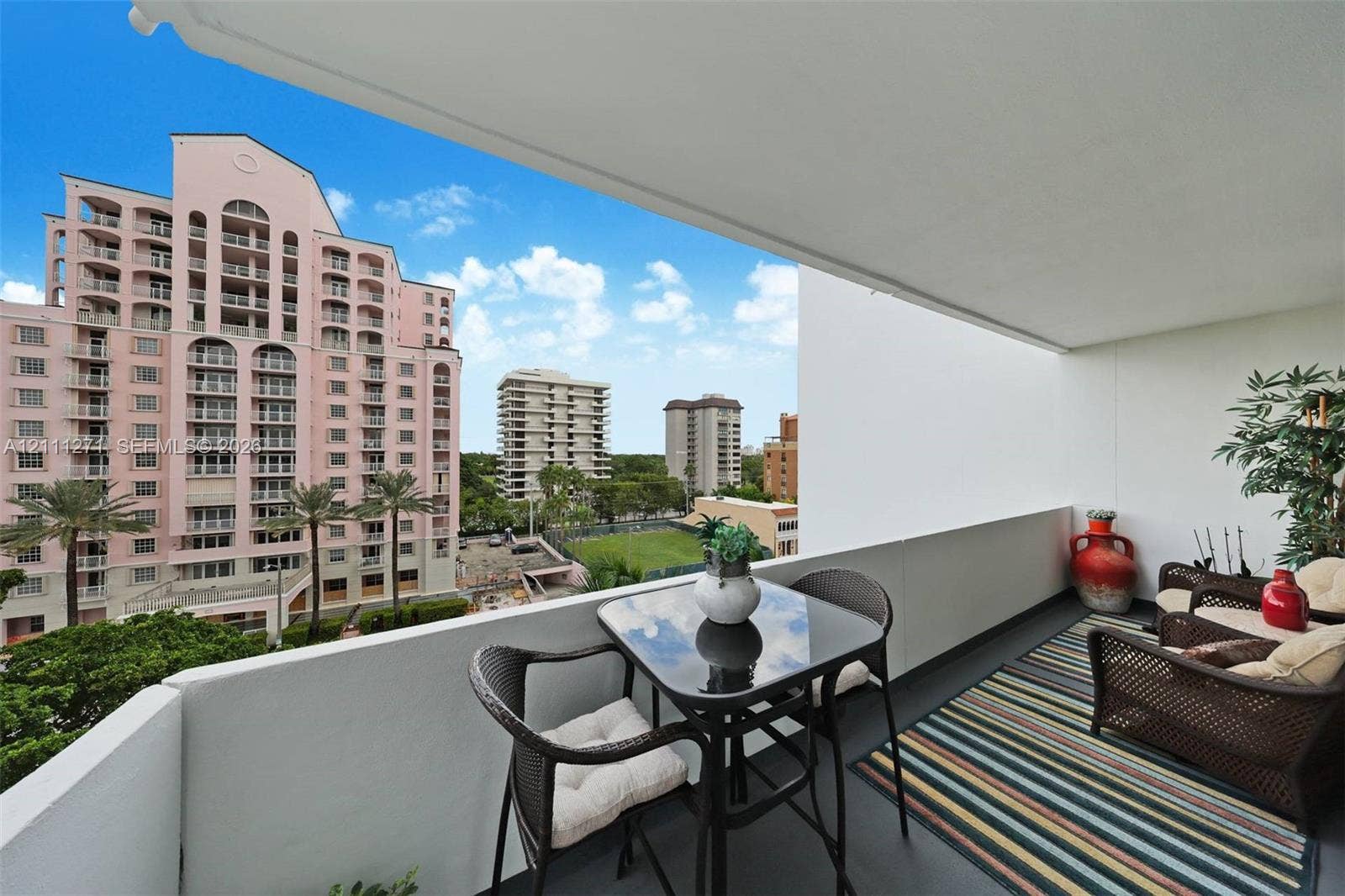 Covered outdoor terrace featuring a solid wall perimeter and concrete flooring