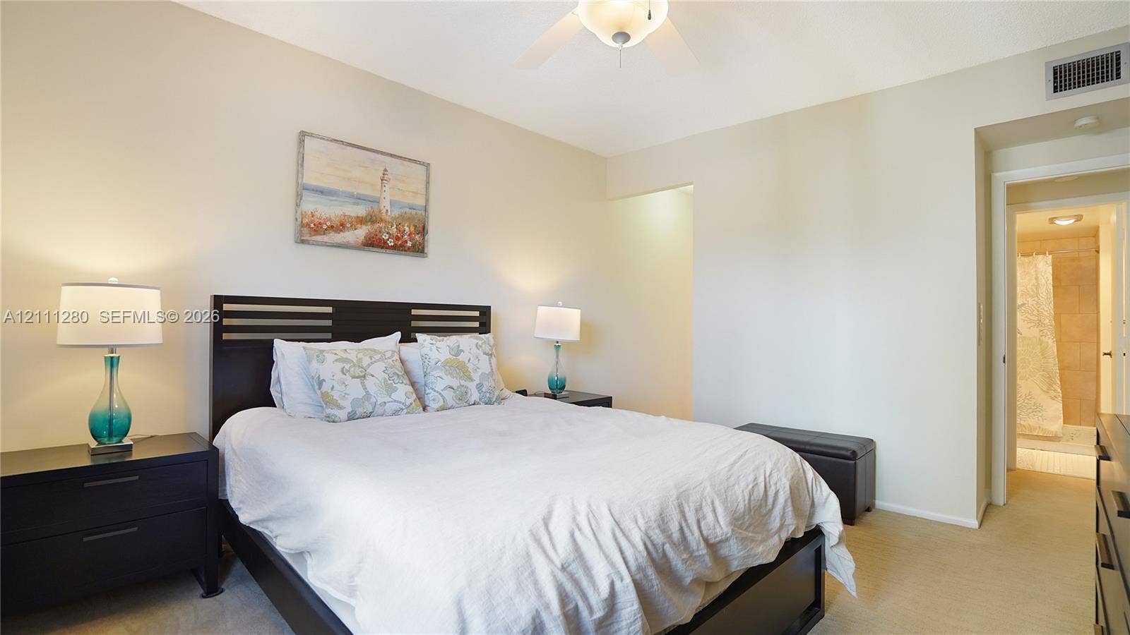400 N Riverside Drive, #305, Pompano Beach, FL 33062 Neutral-toned interior space featuring a ceiling fan with integrated lighting and carpeting