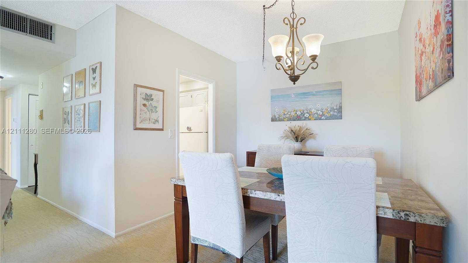 400 N Riverside Drive, #305, Pompano Beach, FL 33062 Dining area featuring a decorative metal chandelier and neutral wall tones