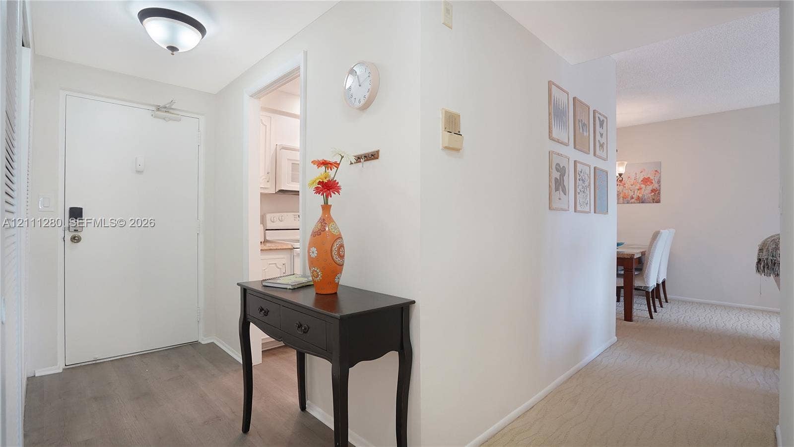 400 N Riverside Drive, #305, Pompano Beach, FL 33062 Entryway featuring wood-finish flooring, a neutral color palette, and a flush-mount ceiling light fixture
