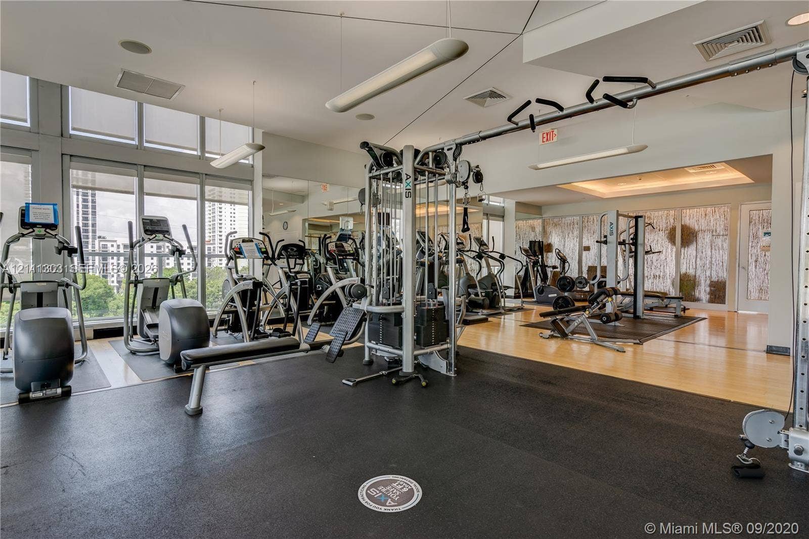 1111 SW 1st Avenue, #2324-N, Miami, Miami, FL 33130 Fitness center featuring wall-to-wall mirrors, floor-to-ceiling windows, suspended linear lighting, and durable rubberized flooring