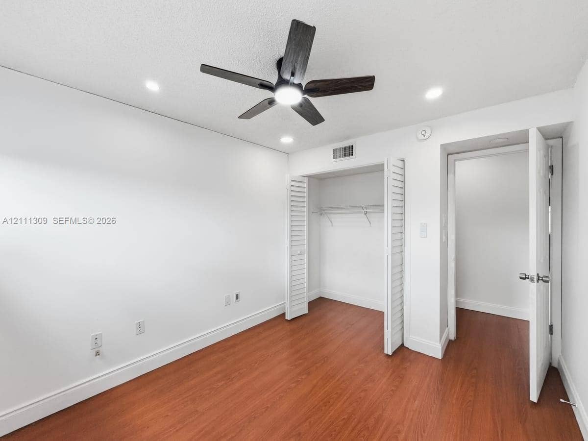 6518 Kendale Lakes Drive, #809, Miami, Miami, FL 33183 Room featuring wood-finish flooring, recessed lighting, a ceiling fan with integrated light, and a closet with bifold doors