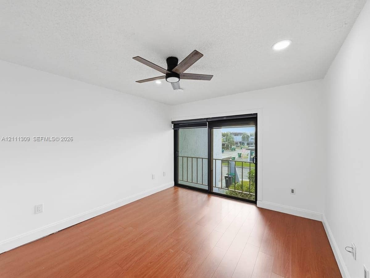 6518 Kendale Lakes Drive, #809, Miami, Miami, FL 33183 Interior space featuring wood-finish flooring, sliding glass door, recessed lighting, and a modern ceiling fan with a dark wood finish