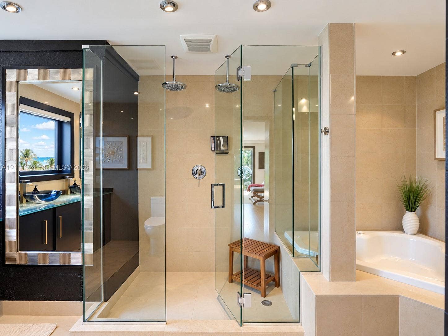 Enclosed glass shower with dual overhead rainfall fixtures, porcelain-tiled walls, built-in corner soaking tub, and vanity with an integrated vessel sink