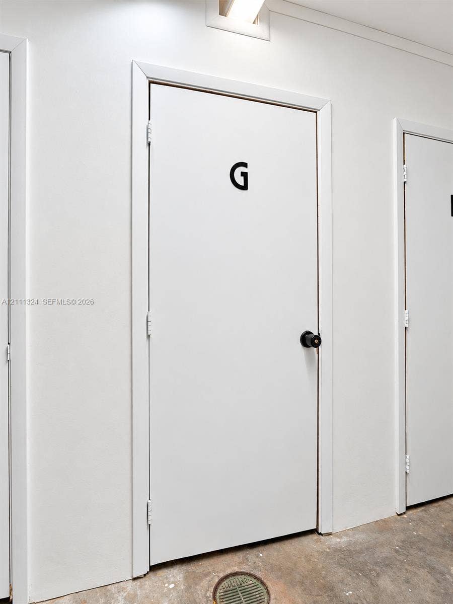 Smooth-finish white interior doors featuring matte black round door knobs and casing trim