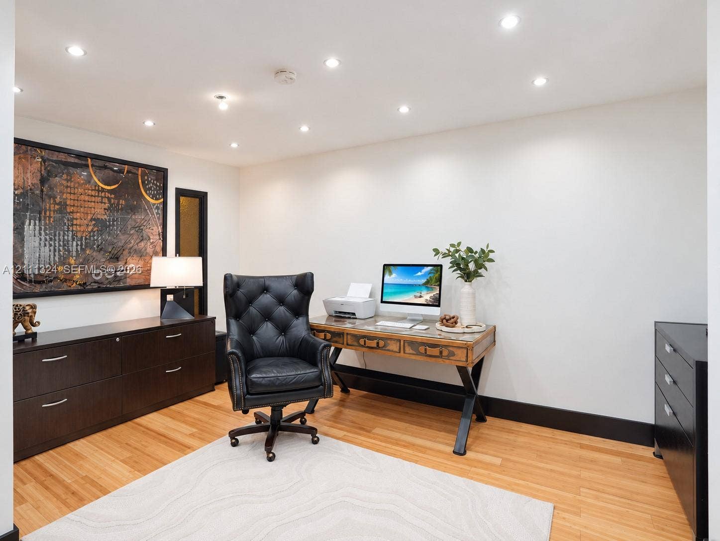 Interior space featuring wood-finish flooring, recessed lighting, and bold dark-toned trim