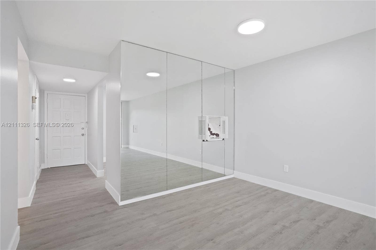 4801 Esedra Court, #207, Lake Worth, FL 33467 View of dining area from living room with entrance in the distance.