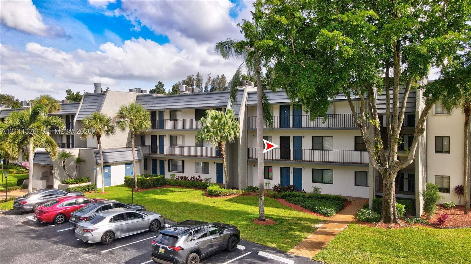 4801 Esedra Court, #207, Lake Worth, FL 33467 This is the front of the building with a red arrow showing the location of the unit.