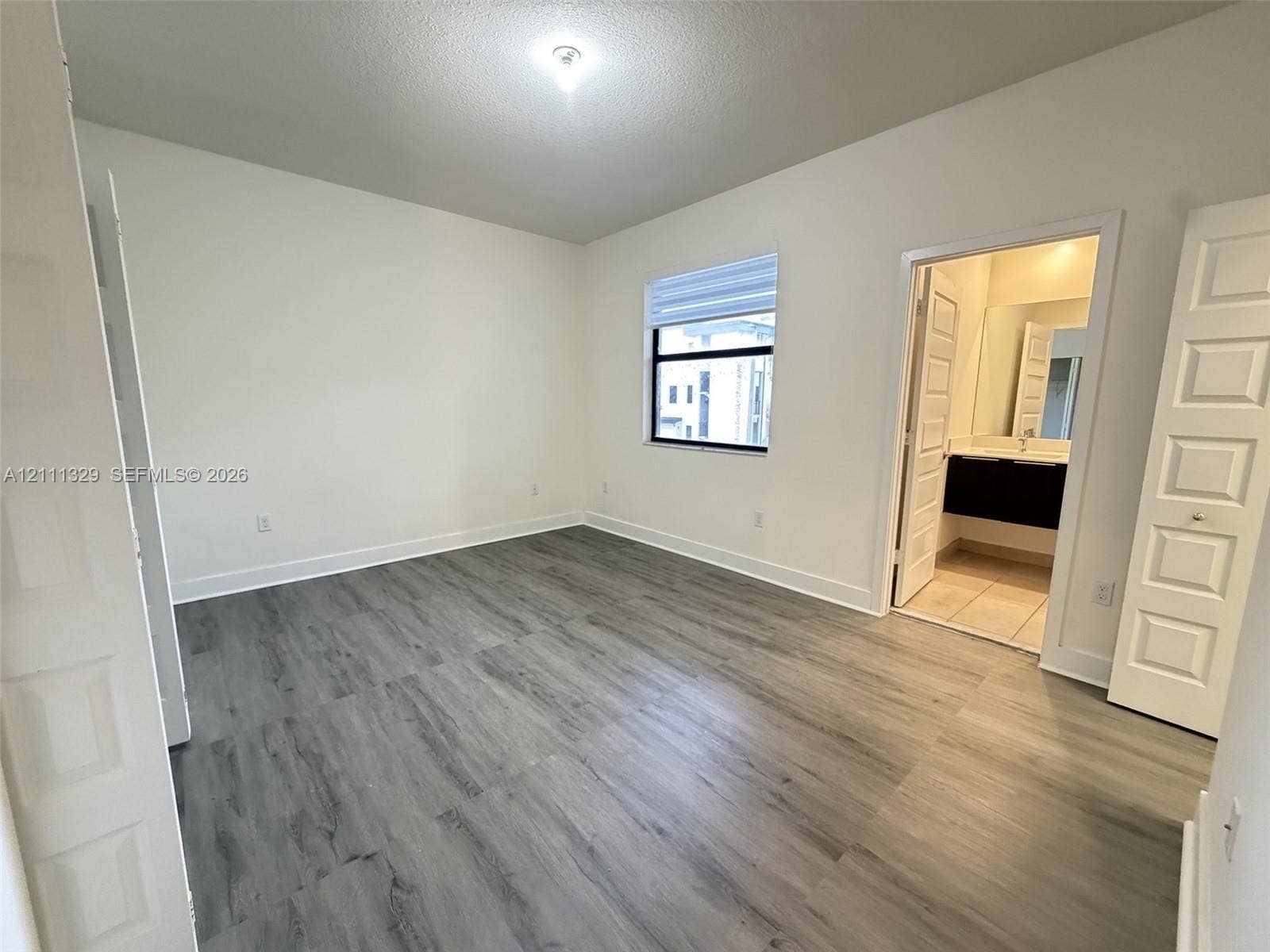10443 NW 82nd Street, #6, Doral, Doral, FL 33178 Room featuring wood-finish flooring, recessed lighting, white panel doors, and a window with integrated blinds