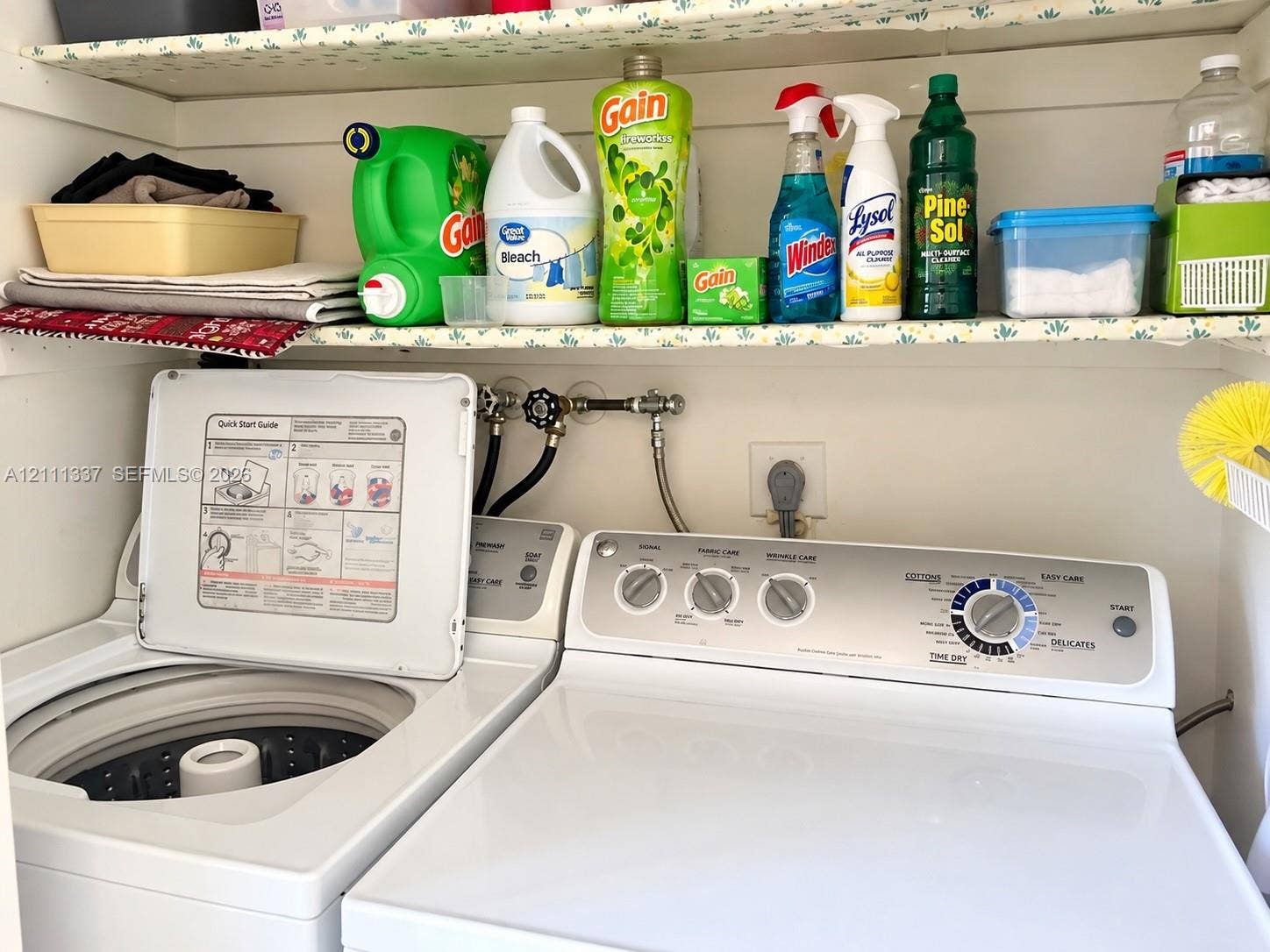 Laundry area featuring a top-loading washing machine, a side-by-side dryer, and built-in shelving