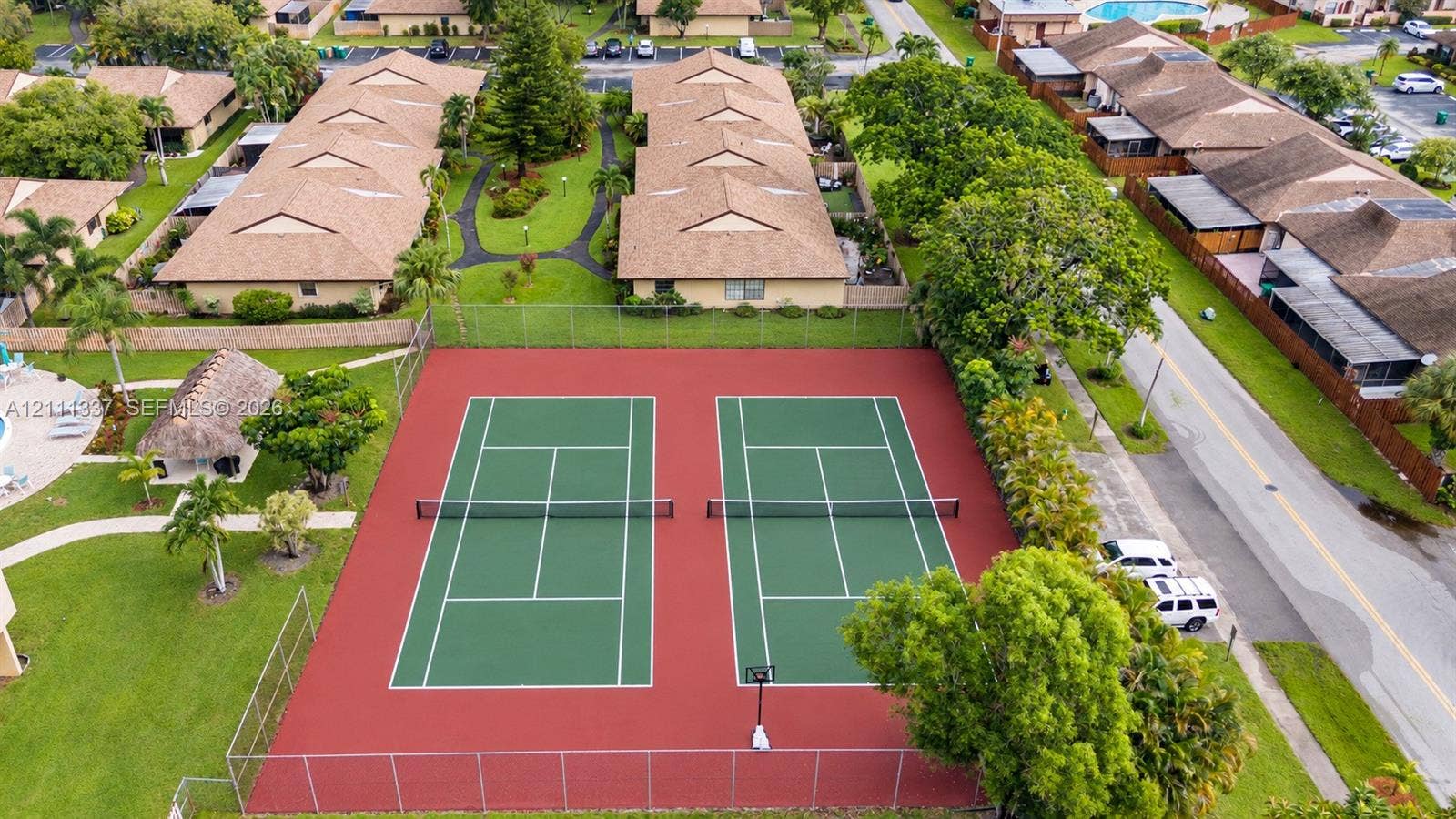 Dual tennis courts featuring chain-link fencing and professional-grade hard surfacing