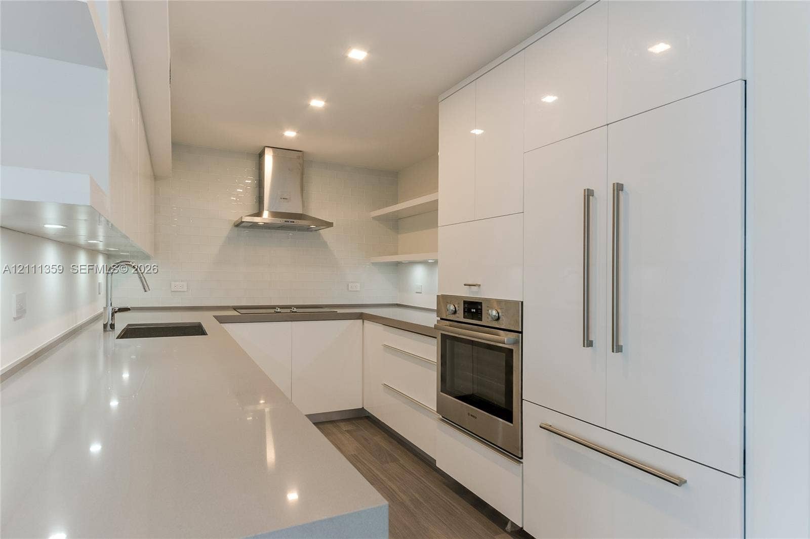 11 Island Avenue, #908, Miami Beach, Miami Beach, FL 33139 Kitchen featuring white high-gloss cabinetry, solid surface countertops, stainless steel appliances, open shelving, and wood-finish flooring