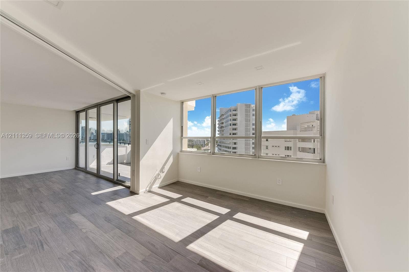 11 Island Avenue, #908, Miami Beach, Miami Beach, FL 33139 Open-concept interior featuring wood-finish flooring, floor-to-ceiling windows, recessed lighting, and sliding glass doors