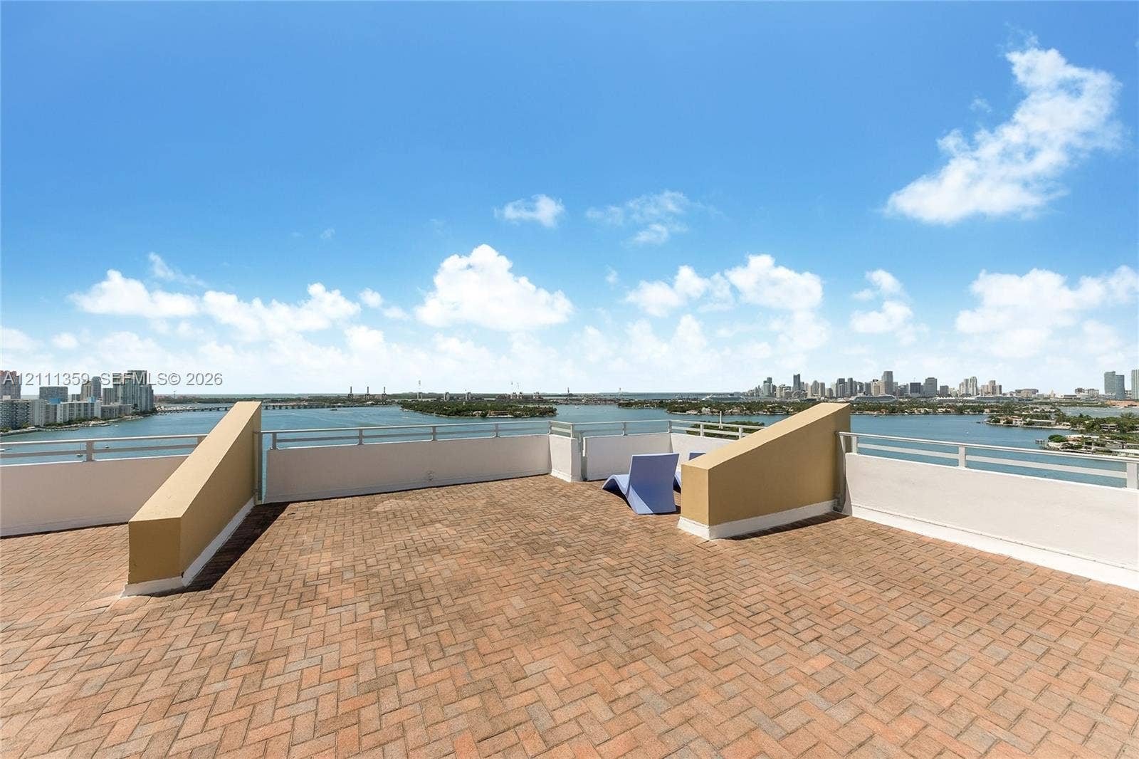 11 Island Avenue, #908, Miami Beach, Miami Beach, FL 33139 Expansive rooftop terrace featuring terracotta-style brick pavers, integrated solid-surface perimeter walls, and metal railings