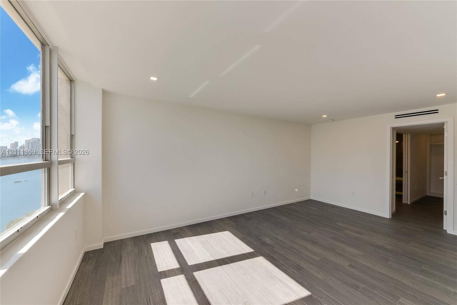 11 Island Avenue, #908, Miami Beach, Miami Beach, FL 33139 Interior space featuring wood-finish flooring, floor-to-ceiling windows, recessed lighting, and a neutral color palette